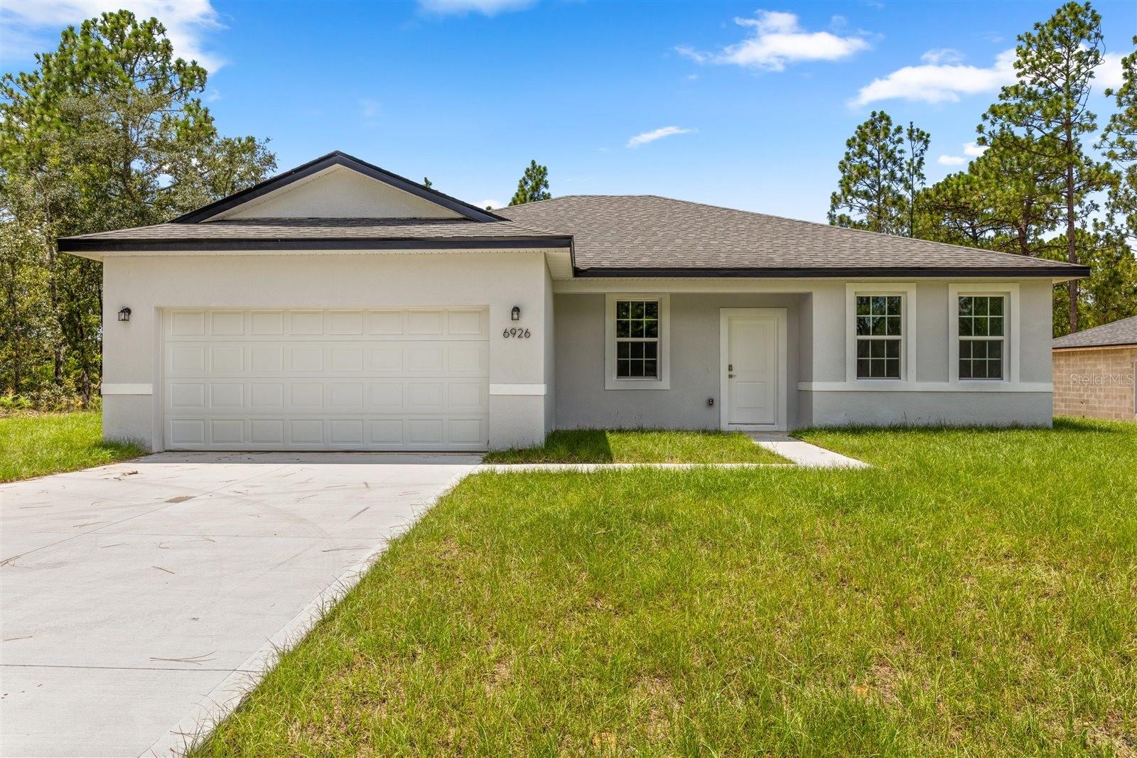 Brand new construction in Citrus Springs! This modern-style home features 4 spacious bedrooms and 3 beautiful bathrooms, offering comfort and functionality for the whole family. Enjoy an open-concept living area perfect for entertaining, complemented by a fully equipped kitchen with stainless steel appliances—including refrigerator, range, dishwasher, and microwave. The kitchen also boasts a large center island and a generous walk-in pantry. Granite countertops add elegance to both the kitchen and bathrooms, while ceramic tile flooring throughout the home ensures easy maintenance. With 1,827 sqft of heated living space (2,351 sqft total), and a 2-car garage, this property combines style, space, and convenience in one of Citrus Springs' most peaceful settings.