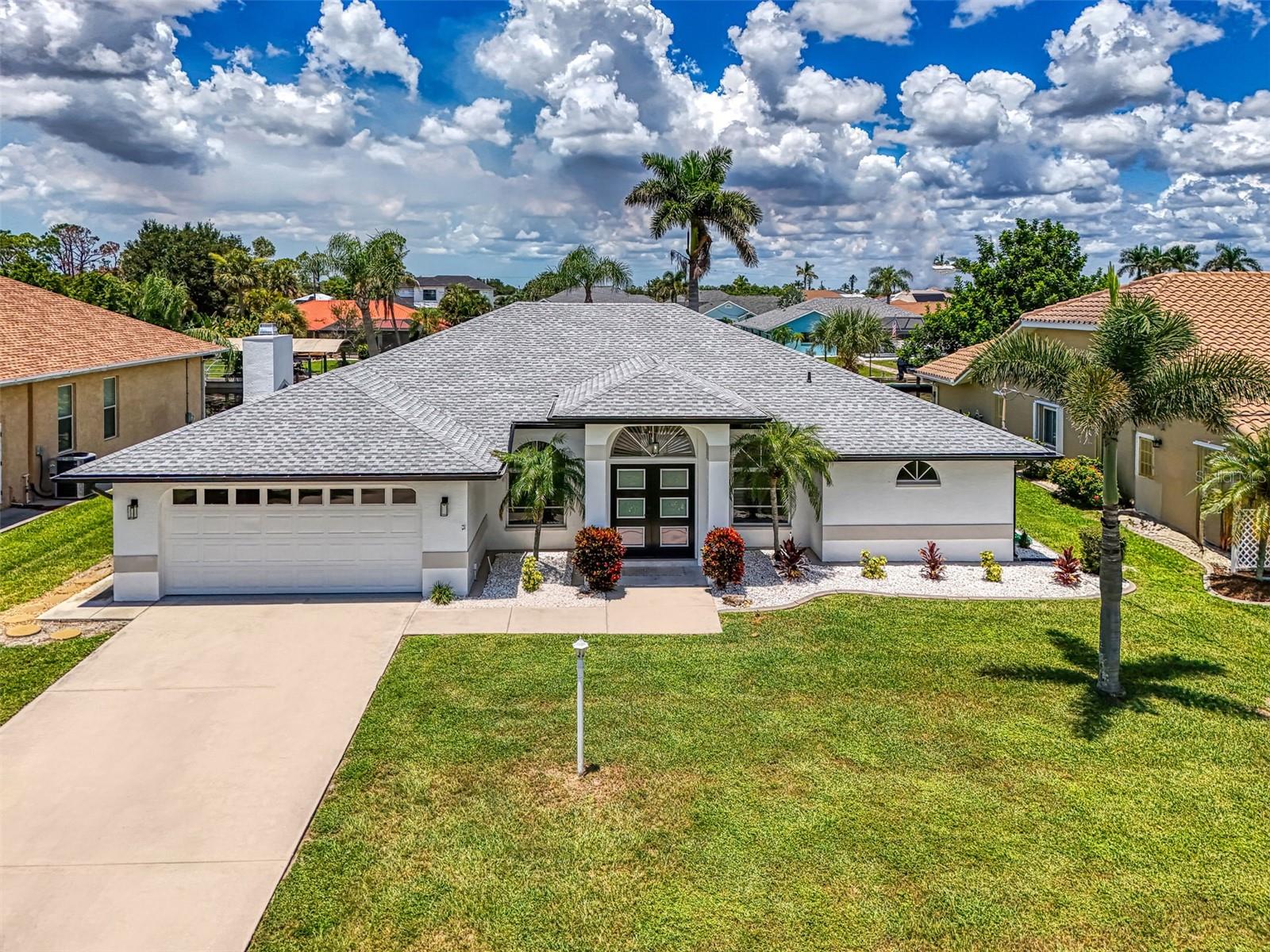 Experience the luxury of waterfront living with this fully remodeled pool home, located in the highly sought-after Gulf Cove community. From the moment you step through the grand double entry doors, you are greeted by a breathtaking view of the sparkling pool and serene water beyond. This home has been thoughtfully redesigned to offer both comfort and elegance, making it the perfect space for entertaining guests or simply enjoying quiet moments by the water.
The spacious floor plan features a cozy family room with a stunning wood-burning fireplace and a built-in WET bar, creating an inviting atmosphere for gatherings. Adjacent to the family room, you'll find a separate living room that provides additional space for relaxation or formal entertaining.
The luxurious master suite is positioned on the opposite side of the home from the two guest bedrooms, ensuring maximum privacy. Enjoy spectacular water views right from your bed, and indulge in the spa-like master bath, complete with an oversized double shower, dual sink, and two expansive walk-in closets. Throughout the home, elegant plantation shutters adorn every window, adding a touch of timeless sophistication.
Both guest bedrooms are generously sized and feature walk-in closets, offering ample storage space for all your needs. The chef’s kitchen is a true highlight, with brand-new, high-end appliances, sleek countertops, and a large pass through window that overlooks the water, allowing you to enjoy the beautiful scenery while you cook.
Step outside to the newly renovated lanai and pool area, where you'll find brand-new scenic pool screens offering uninterrupted views of the tranquil waterway. Whether you’re swimming, lounging, or entertaining, this space is designed to maximize your enjoyment of the outdoors.
For boat lovers, this property is a dream come true, with its private dock equipped with electricity and a boat lift, giving you direct access to the water whenever you choose. The decking was just replaced. Don’t miss the opportunity to own this completely remodeled, waterfront masterpiece. Make this stunning home yours today and start living the dream! FOR THOSE OF YOU WONDERING THIS HOME HAS NEVER FLOODED