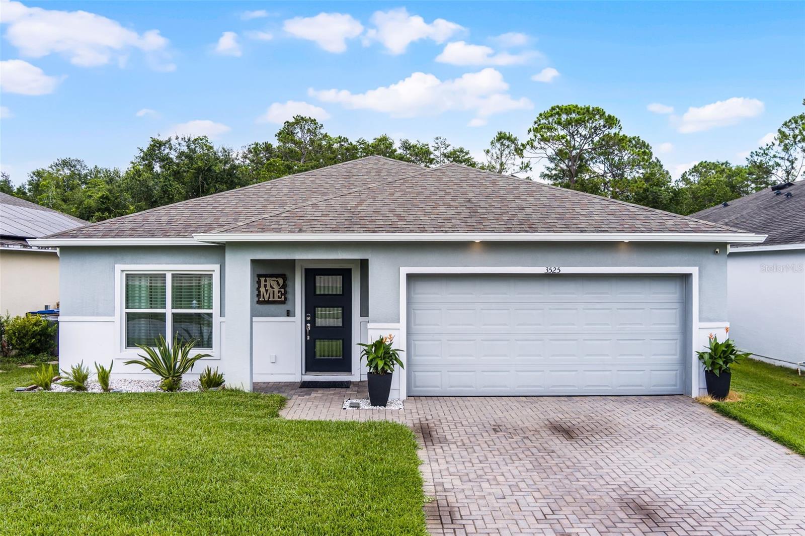Welcome to 3525 Davenport Creek Ct, a charming and energy-efficient 4-bedroom, 2-bath home located in the heart of Kissimmee, FL. Nestled in a vibrant community with access to a pool and playground, this thoughtfully updated home combines modern upgrades with cozy functionality, perfect for everyday living and entertaining. Step inside to find a welcoming front sitting room and beautifully upgraded wood-look LVP flooring throughout the main living areas. The spacious kitchen features 42" cabinets, a large island, pantry, and a unique stove with a built-in air fryer. Just off the kitchen, a bright dinette opens to the family room, creating a natural flow for gatherings and everyday relaxation. The well-laid-out floor plan includes all four bedrooms in one wing of the home, ideal for families or shared living. The primary suite features a private ensuite with dual sinks and a step-in shower. A second full bath includes a tub and a recently updated sink. While the carpeted bedrooms could benefit from restructuring, the layout and space offer incredible potential. Additional highlights include a large laundry room with built-in A/C, linen closet, and fiber internet for lightning-fast connectivity. The garage is a true bonus with upgraded painted flooring, hanging shelves with integrated lighting, and even a refrigerator—perfect for extra storage and convenience. Outside, enjoy the expansive screened-in porch with sun sails for shade and comfort, a partial fence for added privacy, and an irrigation system to keep your landscaping lush year-round. The home is also equipped with a brand-new solar wall, keeping electric bills impressively low—ranging from just $11 to $30 even in peak summer months. Appliances convey, including the washer, dryer, and mounted TV (seller is open to leaving white furniture as well). Whether you're looking for a primary residence or investment opportunity, this home is move-in ready with low-cost, high-efficiency living. Don’t miss this fantastic opportunity—schedule your private tour today!