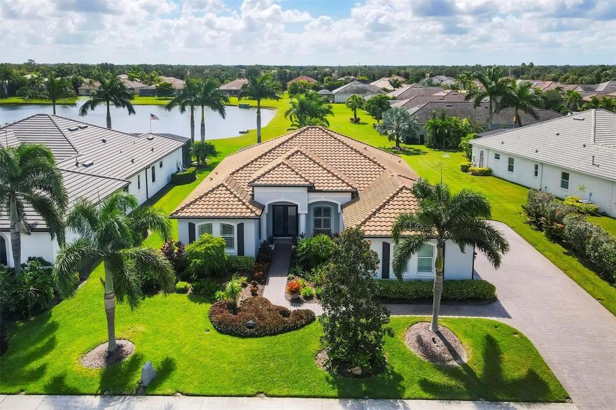 Pride in ownership radiates from the moment you pull in the beautiful pavestone driveway. This pool home is an absolute "10" with a bright, open layout, water views, and space designed for everyday living and effortless entertaining. Step inside to a light-filled living area with high ceilings and clear sightlines straight through to the lanai and pool beyond. To the left of the entry, a versatile den offers room for a home office, nursery, reading nook, or creative space. The formal dining room sits nearby, perfectly placed for hosting family dinners or weekend get-togethers. The kitchen brings both function and warmth, featuring granite countertops, stainless steel appliances, ample wood cabinetry, and bar-height seating for easy breakfasts or casual conversation. Just off the kitchen, a sunny dinette framed by windows creates the perfect morning coffee spot, while the living room offers plenty of space to unwind or entertain with views of the pool glimmering outside. The primary suite feels like its own private retreat, complete with tray ceilings, lanai access, and an en suite bathroom offering dual vanities, a soaking tub, and a walk-in shower. Two additional bedrooms share a full bath between them, and a convenient half bath off the lanai adds easy access for guests. The laundry room includes cabinetry and a utility sink for daily convenience. Outdoors, the screened lanai delivers the ultimate Florida lifestyle—with a sparkling pool, covered sitting area, and tranquil lake views that stretch beyond the screen. Whether you’re hosting sunset gatherings, floating under the afternoon sun, or winding down with a drink in hand, this space captures everything people love about life on the Gulf Coast. A side-load 3-car garage completes the home with generous storage and protection from the Florida heat—ideal for vehicles, tools, or toys. Tucked within the gates of The Enclave at Country Meadows, this home offers a bright, inviting atmosphere and a backyard that captures everything people love about Florida living—where every day feels a little lighter, warmer, and more relaxed.