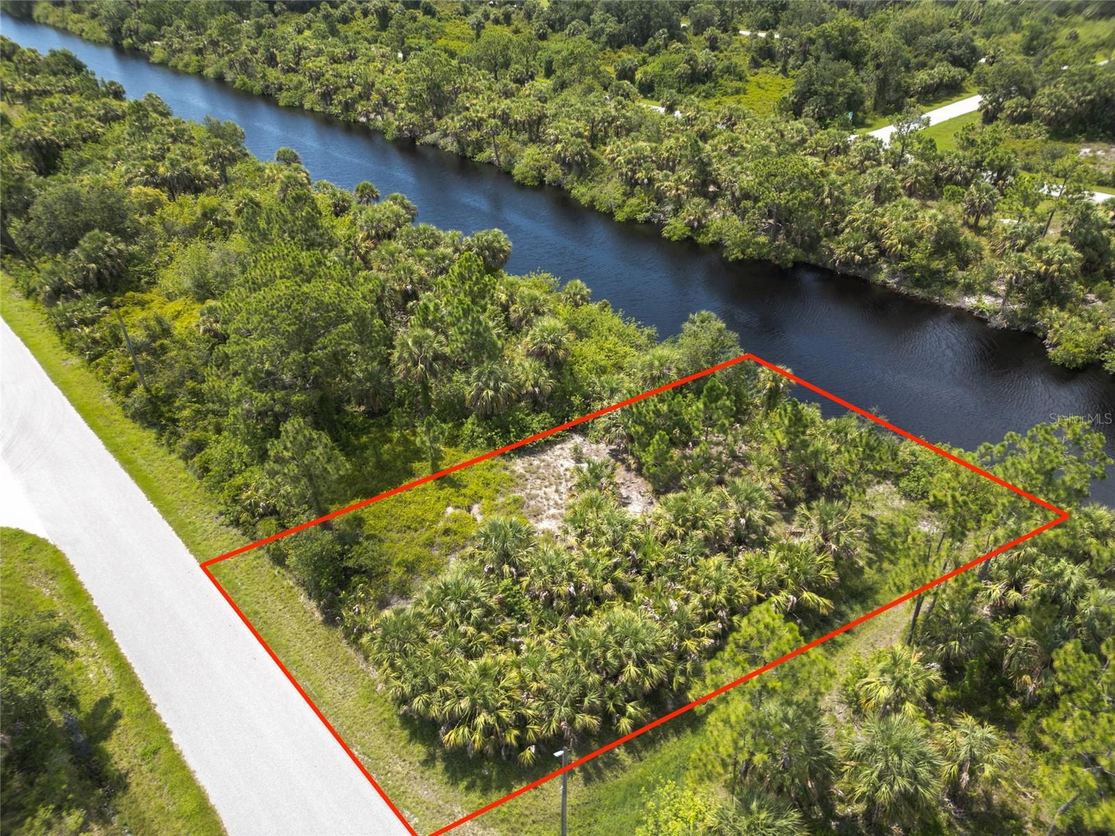 Welcome to your beautiful canal-front lot in Port Charlotte, FL. Nestled in a quiet, establishing neighborhood, this vacant residential parcel offers peaceful water views and direct access to Florida’s scenic waterways—ideal for boating, kayaking, or simply relaxing by the water. The lot is partially cleared, zoned for residential new construction with standard utilities nearby. With no HOA or CDD restrictions, you’ll enjoy the freedom to design and build a home that fits your vision and lifestyle. Conveniently situated near US-41 and I-75, this location offers easy access to shopping, dining, medical facilities, golf courses, and some of Southwest Florida’s most beautiful Gulf beaches. Whether you’re planning a full-time residence, a winter retreat, or an investment property, this lot combines the best of tranquil waterfront living with everyday convenience. Don’t miss this opportunity to own a slice of paradise—come see it for yourself today!