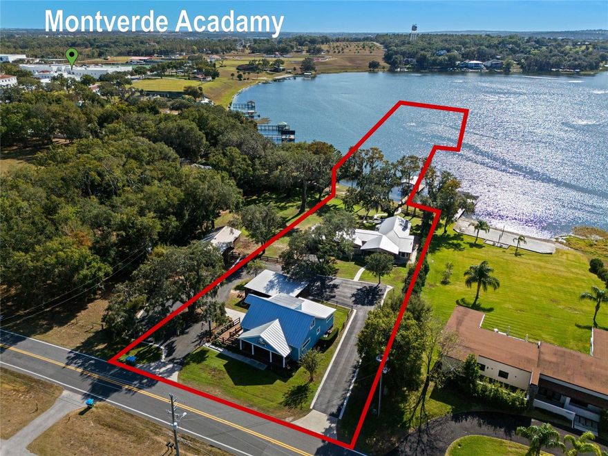 MONTVERDE hacienda offers ONE lakefront home, ONE commercial office & ONE lakefront buildable lot on LAKE FLORENCE!  All parcel combined total  9.07 acres however only 1.33 acres are dry. The Lake house sits on .52 of an acre, the additional buildable lakefront lot is .29 of an acre and the commercial office sits on .52 of an acre with the remaining of the property in the lake. FIRST is the three bedroom~two bath LAKEFRONT HOME with 2337 heated SF & offers AMAZING VIEWS with LARGE picturesque windows to show off the lake and offer a panoramic high elevation view. The custom kitchen has solid wood cabinets (with plenty of storage with roll out shelves), quartz counter tops and stainless steel built in commercial KITCHEN AIDE appliances, including a separate drawer refrigerator AND an ice maker, for lake living! The living room is oversized with beamed cathedral ceilings and once again amazing views of the lake. Enjoy the wood burning stacked tile fireplace on those few Florida cold nights. The master bedroom measures a nice size, once again offers great lake views along with a nice sized walk in closet with custom adjustable shelving. The master bath has a walk in oversized shower with multiple shower heads, dual sinks &  plenty of storage. The two remaining bedrooms are good size as well and one bedroom even has a barn door to offer a little privacy of that bedroom and the guest bath. The laundry room is OVERSIZED and could easily double as a craft room. Wood looking plank tile, crown molding and 5 1/4" base throughout. EXTENDED two car garage plus a garage door off the back to offer a great lake cross breeze ventilation while tinkering in the garage. Plenty of additional storage under the living room with exterior access.  Enjoy the  brick fire pit and lake views under the LARGE OAK TREES after a long day. The property is complete with a covered boat dock including hoist with  power and water. METAL roof and AC was installed in 2018.  NEXT is the buildable LAKEFRONT lot that measures .29 of an acre and you can't but notice the granddaddy OAK TREES.  This parcel does offer a private boat ramp  and you can BRING ANY BUILDER & NO TIME LIMIT to build. This parcel has a barn that measure approximately 1104 square feet and has two oversized stalls, two storage rooms additional covered space. LASTLY is the commercial office space which is zoned ORC, Office Residential Commercial. The property can be used as commercial OR residential!  The building is 1892 SF heated & is currently being used as as office space however there are many options on the permitted use list.  It currently has a reception area, three large office rooms, conference room, full size kitchen (complete with kitchen appliances) & an upstairs BONUS room currently being subleased. The bonus room has a kitchenette area, complete with a kitchen sink and drawer fridge. The bonus room space has a separate exterior entrance as well as an interior entrance and can be locked off. This building has two full bathrooms and one half bath. The building can also be used as a residence and would be a three bedroom ~ two full bath and one half bath and is pre plumbed/wired for a shower and stackable  laundry in the handicap bathroom. Office completely remodeled in 2015. PLENTY of parking as well as an additional three bay carport.  Entire property is fully irrigated by a 5 horse power pump from the lake plus multiple lamp post  throughout to offer a nice evening ambiance. A MUST SEE!