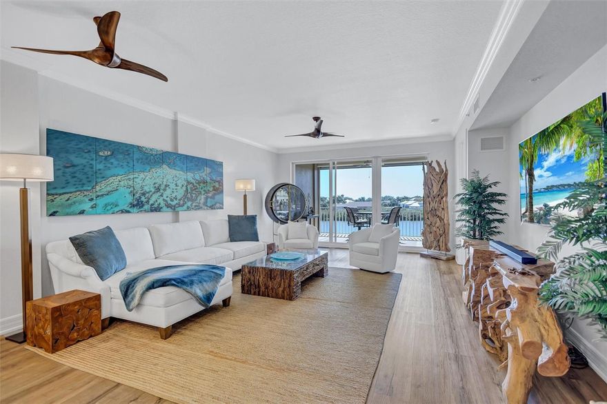 Experience effortless coastal living in this stunning third-floor FURNISHED waterfront residence, perfectly positioned for boaters and kayakers in protected waters just off Blackburn Bay and minutes from the Intracoastal Waterway and Gulf. Watch dolphins, manatees, otters, and breathtaking sunsets from your private balcony. Your water views continue inside, flowing through the living room, dining area, kitchen, and primary suite. This spacious, designer-furnished home showcases quartz surfaces, tile and luxury vinyl flooring, a primary suite with balcony access, oversized shower, jacuzzi tub, and three closets.  This unit includes a beautifully appointed second bedroom and a versatile den that is currently used as a 3rd bedroom. There is ample storage inside and out- including a first-floor storage unit ideal for all your water toys. Use the community kayak launch for access to Blackburn Harbor and Oscar Scherer State Park. Enjoy the rare opportunity to keep your boat in your backyard with dockage currently available. Your home is set within an 11-acre gated community featuring walking trails, tennis and pickleball courts, a resort-style pool, waterside grill, clubhouse, and fitness center, all just minutes from Nokomis Beach, the Legacy Trail, and vibrant dining and shopping—this is truly the ultimate Florida waterfront lifestyle you’ve been waiting for.