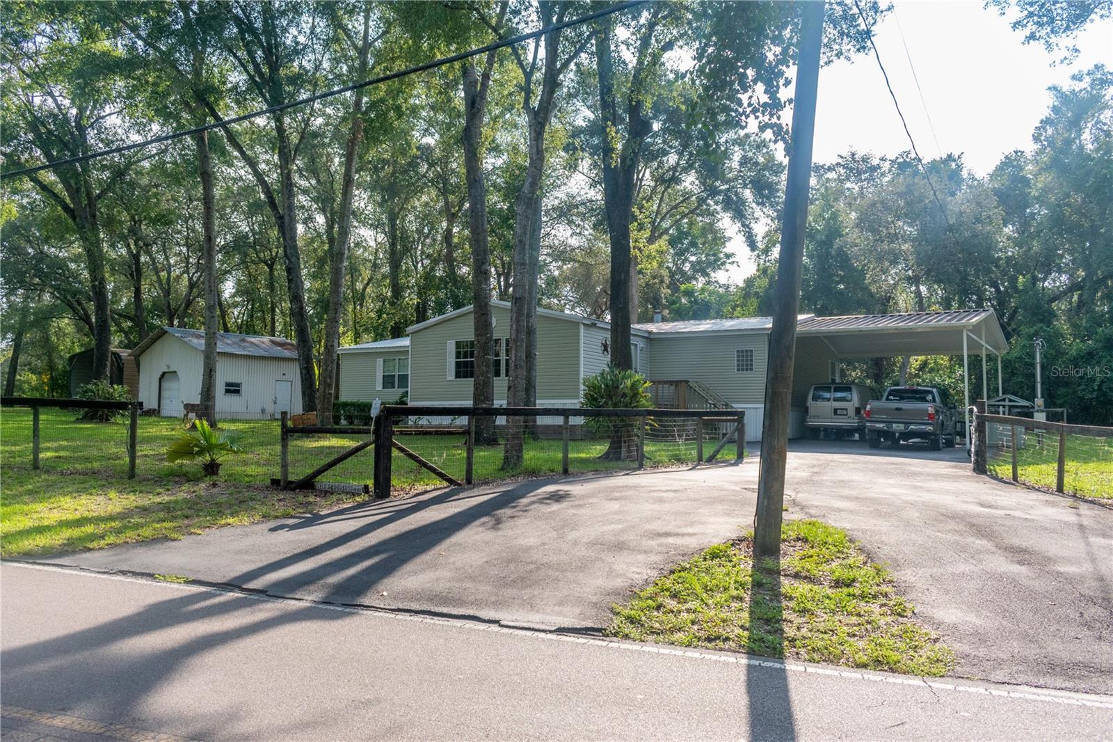 Welcome to 16030 Hays Road, on a corner lot, a spacious doublewide manufactured home nestled on a full 1+ acre lot. Built in 2004, this thoughtfully designed 2,416 sq ft residence features open flexible living spaces including living room open to family room, 3 bedrooms or bonus rooms, two full baths, a cozy fireplace, and a mix of wood laminate and carpet flooring throughout. Metal roof 2020. Well, septic, X flood zone and zoned AR makes for affordable living. Paved driveway too! Also on a paved road.
Outdoor amenities include private mature landscaping and ample area for expansion or customization. The property’s detached garage and seperate 2 carports offers additional functional space. Situated in a peaceful semi-rural setting, yet convenient to schools, shopping, and regional thoroughfares. 589 access close by. Its a must see! Hurry before its gone!