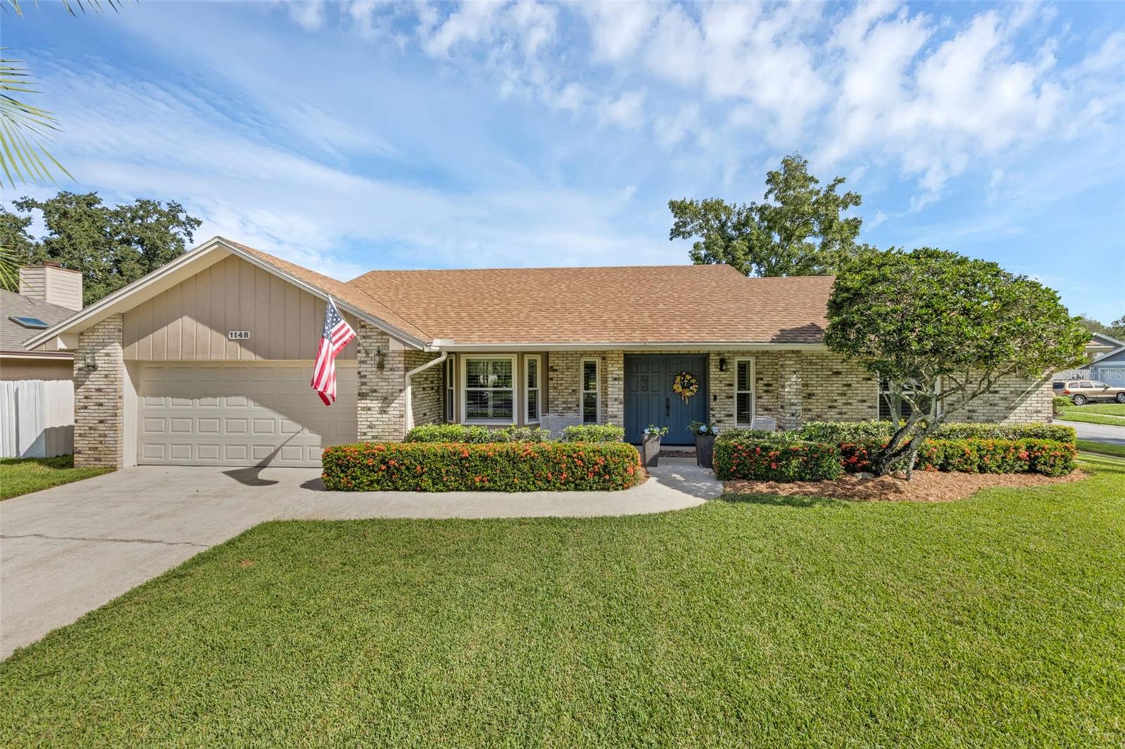 Meticulously maintained by its original owners for 37 years, this beautifully updated home is filled with natural light, timeless details, and modern upgrades. The bright, open floor plan features 3 bedrooms, 2 full baths, and soaring ceilings with skylights and plantation shutters. Wood and travertine flooring flow through the main living areas, while the two guest bedrooms offer cozy carpeting. A built-in study area with desk and a 6x5 storage room loaded with shelving add function and convenience. Major updates include roof (2018), A/C (2019), replumbed water lines, new septic and drainfield (2018), updated windows, exterior paint (2019), and a digital irrigation system (2024).
The kitchen is a showstopper with custom cabinets, granite counters, a tile backsplash, glass cooktop, built-in microwave, breakfast bar, pantry, and informal dining space, all enhanced by high ceilings and decorative plant shelves. The family/living room impresses with vaulted ceilings, wood floors, a handsome brick wood-burning fireplace, double wood entry doors, and French doors leading to a large screened and covered patio/back porch. The primary suite is a luxurious retreat with wood floors, French doors to the back porch, a 10x7 walk-in closet, and a spa-like bath with dual vanities, a jetted soaking tub, and a stunning floor-to-ceiling tiled walk-in shower. A split-bedroom design ensures privacy, with two spacious guest rooms and an updated bath featuring patio access.
Set on a quarter-acre corner lot, this home offers outstanding curb appeal with impeccable landscaping, a welcoming front porch, and brick-paver side yard with storage shed. The oversized 24x20 garage includes attic access, painted floors, and an exterior door. With updated ceiling fans throughout, plenty of storage, and a wonderful blend of comfort and style, this home is truly move-in ready.
Homes of this caliber, with such thoughtful updates and diligent care, rarely come available. Don’t miss your chance to make 1148 Climbing Rose Drive your new address—schedule your private showing today!