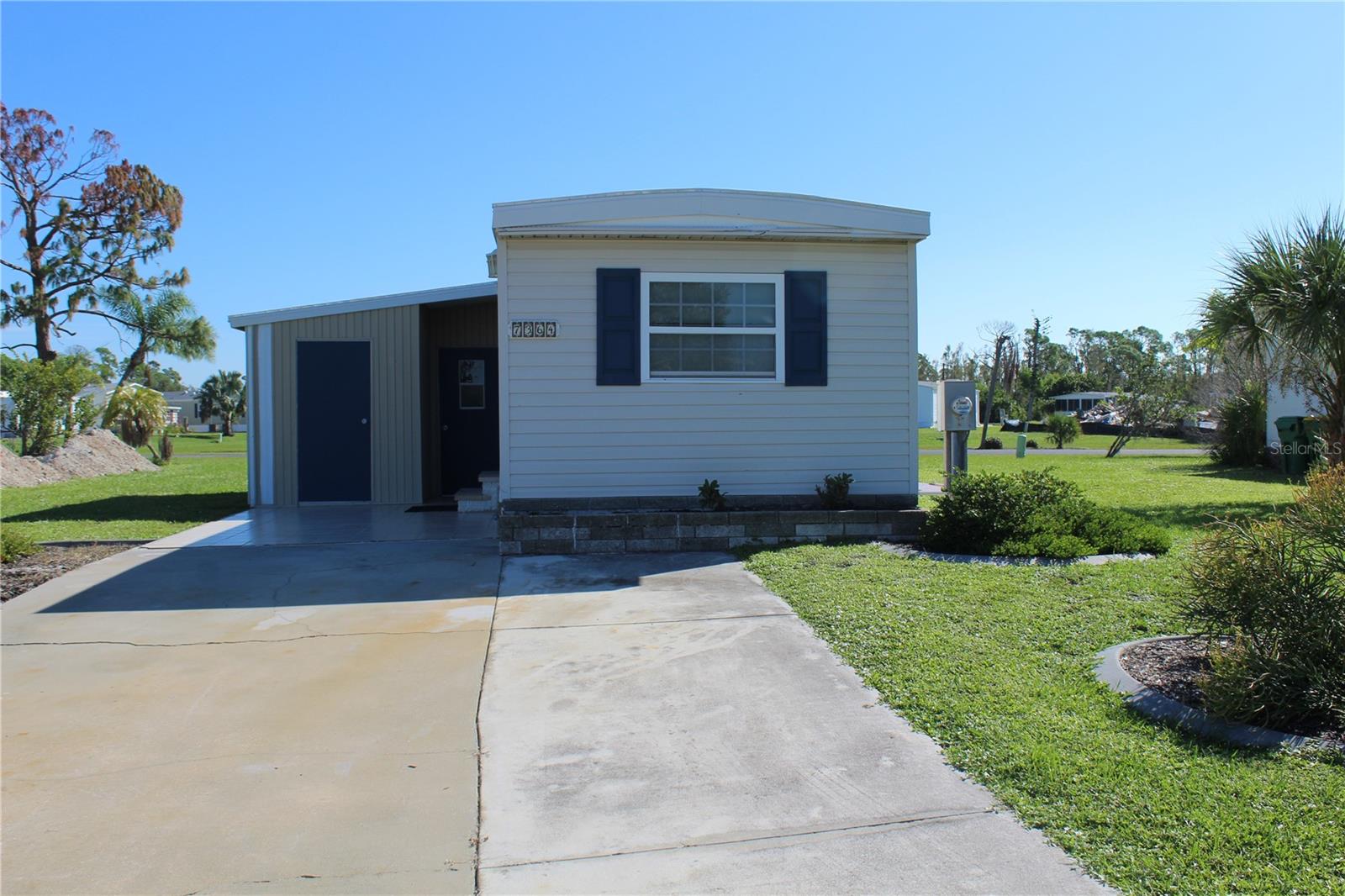 TROPICAL LIVING AWAITS! This 1 bedroom, 1 -1/2 bath home is located in the sought-after Village of Holiday Lake, a WATERFRONT COMMUNITY, with docks and its own boat ramp just minutes to open water, Charlotte Harbor and the Gulf of Mexico! Originally a 2 bedroom and the owners took down a wall to make for an oversized living room. The buyer could easily put up a wall and turn back to a 2 bedroom, if desired. This home offers UPDATED DOUBLE TINTED WINDOWS THROUGHOUT, a NEW ROOF AND NEW VAPOR BARRIER & TIEDOWNS. This property has an updated kitchen, newer washer and dryer and 2 sheds. The AIR CONDITIONER IS A 2021. This property used to be a 2 bedroom and the homeowner took down a wall to make a larger living room and added a small room off the master bedroom as a half bath and closet. This property has 2 sheds. One is used for a laundry room and the other is much bigger and can be used for storage. There are some areas that will need a new subfloor. If you are a golfer you will enjoy some of the area's finest GOLF COURSES all within a couple of miles from home. The Village of Holiday Lake boasts 25+ boat slips, beautiful pool area with 2 pools and BBQ area. There is always something going on at the large recreation hall with full kitchen, craft room, fitness center, laundry facility along with areas for woodworking, tennis, pickleball, shuffleboard and more. Golf Carts welcome. The outdoor enthusiast in you will love the closeness of boating and fishing from the community docks and boat ramp. You will also find several Gulf Shore Beaches close by. The foodie in you will love the local delights like Gerry’s Tiki Hut, TT’s Tiki on the Water and the Sandbar Tiki & Grill all of which can be accessed by boat or by car. The Village is perfect for year round living or a winter get away spot.