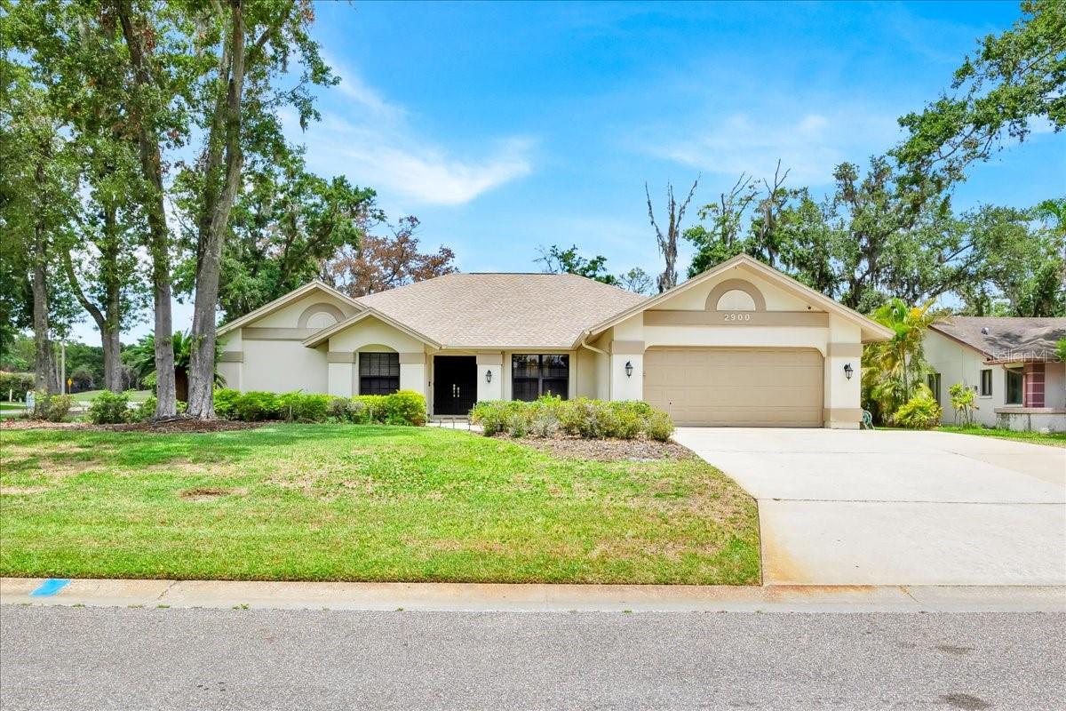 Stunning 3 bedrooms, 2 bathrooms, house inside the amazing community of Walden Lakes. The property is located in the subdivision of The Hammocks, with lush landscaping surrounding the house. This property is perfect for those who love space. As you walk in through the double doors, you will be greeted by the Formal dining and living areas. The floor plan has a split design, and on the right-hand side of the property, you will walk down the hallway passing the kitchen that has 2 open entrances. The kitchen comes fully stocked with new appliances such as a Range, Microwave, Dishwasher, and Refrigerator. There is plenty of counter space for a coffee station or even a bar area. Next is the corridor to the 2-car garage, where you will find the full-sized Samsung washer and dryer. The garage comes with its electric garage opener and a side door access to your trash can location. In the garage are the electrical water heater and A/C HVAC handlers. Back into the property, there are 2 closets, and one would be the best to use as your pantry. Continuing the left side of the hallway are the 2 additional bedrooms and Bathroom #2. You must see the space of these bedrooms and the built-in closets. Back towards the hallways is the Family room area with a wood-burning fireplace for those cold winter nights to cozy up while watching TV. Then you can head through the sliding doors to a bonus area that would be perfect for a game room, or entertainment room with lots of natural light, a wet back with open space to the kitchen, and under A/C so it will continue the cool temperatures from the inside. This bonus area has sliding doors to the back covered porch where the spa sits, and you can fully slide the sliding doors open for extra entertaining, as this area is fully screened in. Back into the main house, you can access the primary bedroom via sliding doors or use the French doors that take you to the main entrance, where the formal dining and living areas are. Towards the right-hand side of the house is where the primary bedroom is located alongside a flex room that is currently used as the owner's 2nd walking closet, but its options are unlimited. It can be a nursery, a game room, or an office, and it has direct access to the primary bathroom. The primary bathroom has a separate shower & toilet area and a total of 3 sinks. The primary bedroom also includes a walk-in closet and a 2nd closet. You must come see all the features that his house has to offer. The property is also located on a corner lot, so lots of extra land to grow. The community has beautiful trails to walk, jog, or ride your bikes, and it is great for families to enjoy the Florida outdoors. Come see this property before it is gone!
