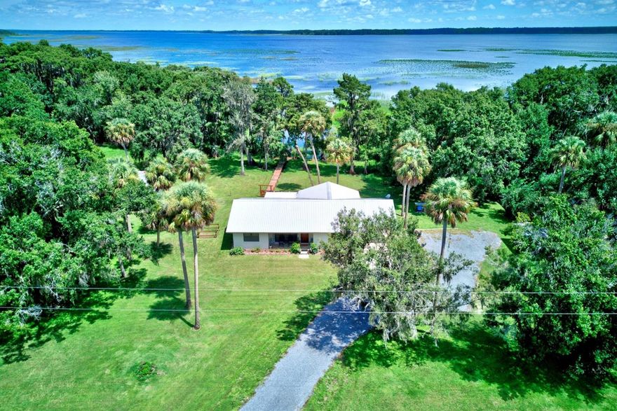 Wow!! Your lakefront dream home is here! Situated on over 1 acre of pristine Florida waterfront land on Lake Arbuckle in Avon Park, FL - this stunning homestead is now ready for new owners to enjoy! Everything on this gorgeous Ranch style home has been masterfully well maintained throughout the years. 3 spacious bedrooms on a split floor plan, 2 full bathrooms & a shower in the indoor utility room, Cypress wood accents, Exterior pole barn with generously sized tack room, dock, plus so much more! The immaculate landscaping and exceptional curb appeal will make you so happy to arrive home in a beautiful setting every day! Upon entering through the front door entryway, the designated formal dining area containing a beautiful view of the front yard is immediately to the left. Continuing into the home reveals the large family room with Lake Arbuckle views through a custom bay window and the HUGE kitchen fully equipped with stainless steel appliances, plenty of cabinet/counter space, and breakfast bar providing for extra barstool seating. Adjacent screened-in back porch incorporates a stunning view of the surrounding land and lake. Super convenient indoor laundry room with shower is located next to the covered carport and exterior storage room! The spacious 14'x13' primary bedroom contains a generous amount of closet space as well as an en-suite bathroom with shower/tub combo. The 2 secondary bedrooms are on the opposite side of the home as well as the 2nd bathroom equipped with a fully tiled walk-in shower. The perfect home for your horse - the 21'x57' pole shed also contains separate stalls and a storage room for your supplies. Artesian well and septic tank utilities. Wood laminate and tile flooring throughout the home. Updates include a recently new well water tank, water heater updated approximately 7 years ago, Boat dock built in 2009, full metal roof replaced in 2004. Lake Arbuckle is a pristine, shallow lake with little offshore structure and maximum depth of 12 feet. Ideal location for an avid fisher since the boat ramp is located close by in the fish camp - trophy bass up to 15 pounds have been caught at Lake Arbuckle in recent years! Residents in this neighborhood enjoy not having to pay any Homeowner's Association or Special District Fees. *Extended family members also own the adjacent 20 acres of land - will be open to offers