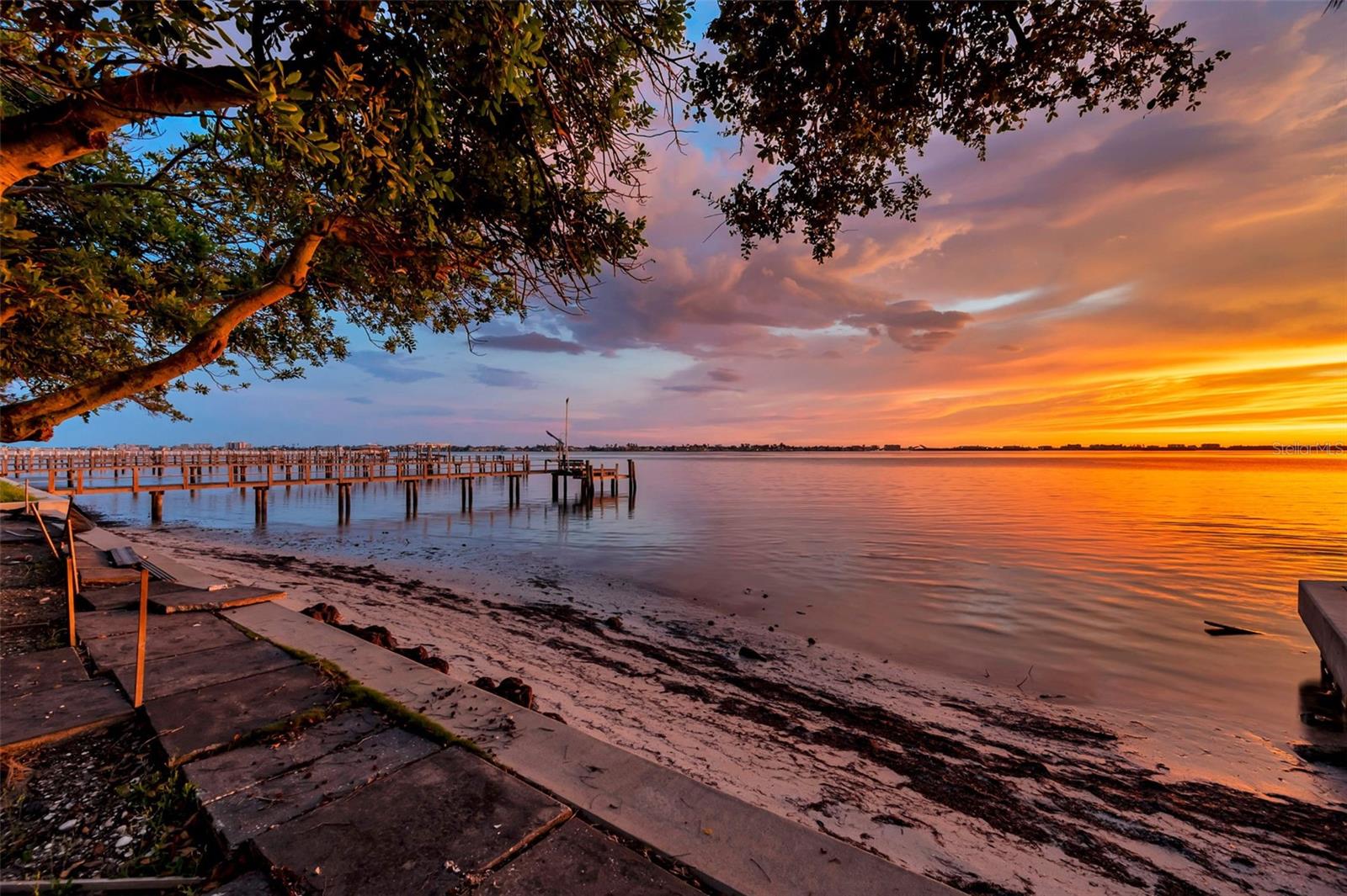 Discover the rare opportunity to build your dream retreat on a cleared waterfront lot in Jungle Shores. Set on the tranquil waters of Boca Ciega Bay, this west-facing gem invites breathtaking sunset views, privacy, and plenty of space to build your dream home.
This generous parcel of land offers direct water frontage with direct boating access, connecting you effortlessly to the Intracoastal Waterway and the Gulf of Mexico. There's no need to navigate canals—the waterway leads you straight into open bay waters and beyond, making it ideal for boating, fishing, kayaking, paddleboarding, or just enjoying the unobstructed sunset views. There's even a beach just beyond the seawall!
Imagine your custom-built home with expansive windows or a waterfront terrace perfectly oriented toward the west, where evening light illuminates the bay with shimmering golds and fiery sunsets over the horizon. The quiet Jungle Shores neighborhood is residential and refined, yet you're just minutes from vibrant downtown St.?Petersburg. Enjoy a variety of top-rated dining, shopping, and arts destinations while returning home to this peaceful waterfront setting. With multi-million dollar estates all around, you can be secure knowing that whatever you choose to build will not be 'overbuilt' for the neighborhood.
A single-story ranch home was recently demo'ed from the site, so all utilities are in place and ready for your new build.
This property represents an exceptional value in the local waterfront market—rarely does a parcel come up in this esteemed neighborhood. Don’t miss the chance to claim this slice of paradise. Prepare to wake up to bay views, launch your boat at will, and end every day with a stunning sunset right from your own backyard beach retreat. Be sure to view the video of the property!!