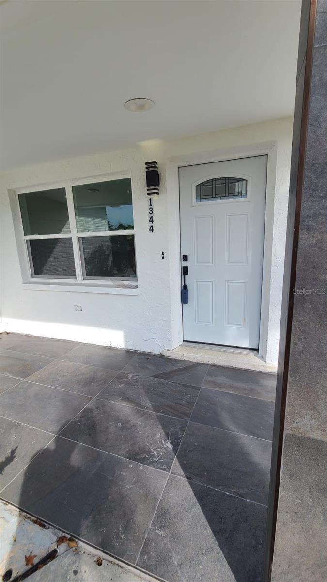 BACK ON THE MARKET! due to buyers financing! You will love this charming, corner lot home in Holiday Florida! It was completed renovated in 2023, featuring modern details that shows everywhere you look at. Bright and beautiful with stunning porcelain tile floors throughout, and SPC in bedrooms, beautiful design in both bathrooms. Porcelain tile slabs in kitchen countertop and backsplash, as well as in accent wall with electric fireplace that will catch your eyes as soon as you enter the house. Plenty of cabinets in kitchen including a pantry. Open floorplan that brings more space for your comfort. Appliances are brand new, as well as all windows, exterior and interior doors. Roof was replaced in 2021 as per public records. All lights, ceiling fans, are also new. Large fenced backyard, with a lot of potential. Nothing to worry about, just bring your toothbrush!!! Don’t miss the opportunity to make this property your own!!! Come today and bring your offer!