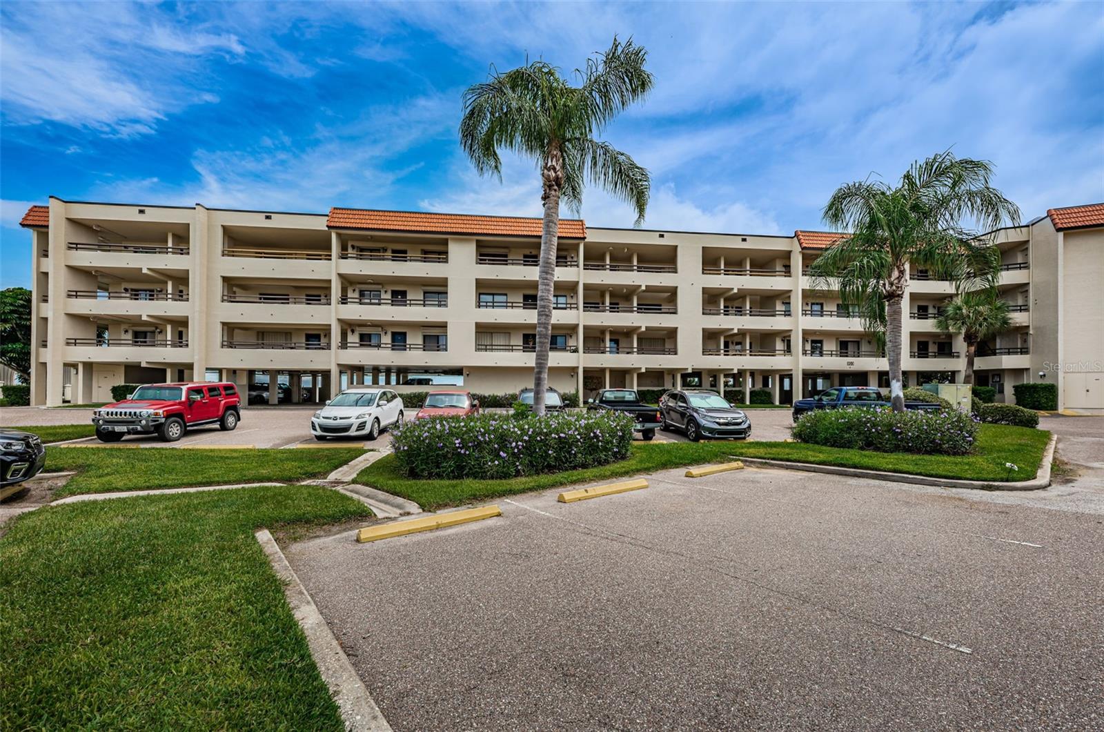 Welcome to the island of Tierra Verde surrounded by the natural beauty of Tampa Bay and the Gulf of Mexico! Located in the Village at Tierra Verde, a resort-style gated community, #208 is a waterfront end unit with 2 bedrooms, 2 baths, 1040 sq ft and stunning views of the Bay. As soon as you enter, your eyes will be drawn to the mesmerizing wide water views, framed beautifully by the hurricane impact sliding doors and windows. The spacious 21 ft balcony, with access from the main living area and master bedroom, will soon become your favorite place to relax anytime of day, watching boats glide by, pelicans diving for fish, and on a lucky day, dolphins swimming by.
The open floor plan is great for entertaining and this end unit has lots of light, wood flooring in the main living area and master bedroom, crown molding in the main living area, an elegantly updated master bath, an interior laundry closet with full-sized washer & dryer, and lots of storage - with a storage closet on the balcony and an exterior storage room on the garage level.
The elevator is just a few steps away from the condo and assigned covered parking space #208 is located in the under-building garage.
The Village at Tierra Verde offers all the amenities necessary to fully enjoy the Florida lifestyle, including 3 geothermal heated and chilled pools (one just steps from Bldg #103 overlooking the beautiful Bay), heated spas, tennis courts, a boat-friendly dock, boat slips to rent or purchase (on 1st come basis), and a waterfront walkway. The Clubhouse facilities include a fitness center, men’s and women’s saunas, a billiard/ library room, and a large party room with full kitchen, great for special events and gathering with neighbors.
In just 10 minutes, you can have your toes in the sand at Pass-a-Grille or St Pete Beach, with lots of great restaurants nearby, or try the award-winning beaches at Ft DeSoto Park. And if you want to fit in some exercise, there is a dedicated walking/biking path to Fort DeSoto. Take a short drive further (just 15 mins.) to charming, artsy downtown St Pete which offers casual and fine dining, museums, theater, art galleries and more! Two international airports are approximately 30 minutes away, making all these sunny vibes very easily accessible. 3-month minimum rentals allowed and 2 small pets welcomed. Just imagine owning a waterfront condo in the Village at Tierra Verde, the premier community to make your dreams come true and enjoy the wonderful Florida lifestyle! This home comes with a 13 month Home Warranty for buyer's peace of mind and to help make transitioning easier!