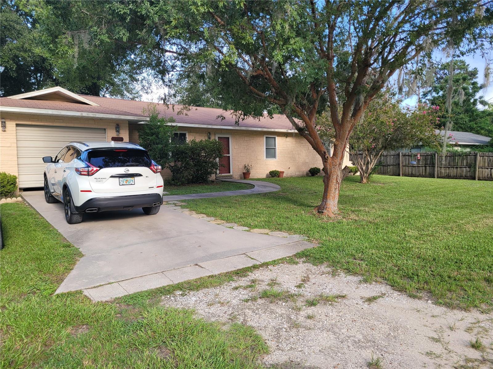 Discover this delightful 3 bedroom, 2 bathroom home, perfectly situated on an expansive, oversized lot offering abundant space. This is a blank canvas for your landscaping dreams, offering endless possibilities for entertaining, gardening, or simply enjoying the Florida sunshine. Imagine the potential for a workshop, an extended patio, or even a future pool! This residence is move in ready awaiting your personal touch with your preferred paint colors to make it truly your own. The well-proportioned bedrooms provide ample space, while the two full bathrooms ensure convenience for families and guests alike. Enjoy the benefits of a prime location, just moments away from a variety of amenities including shopping centers, dining options, parks, and schools. Commuting is a breeze with easy access to major roadways.