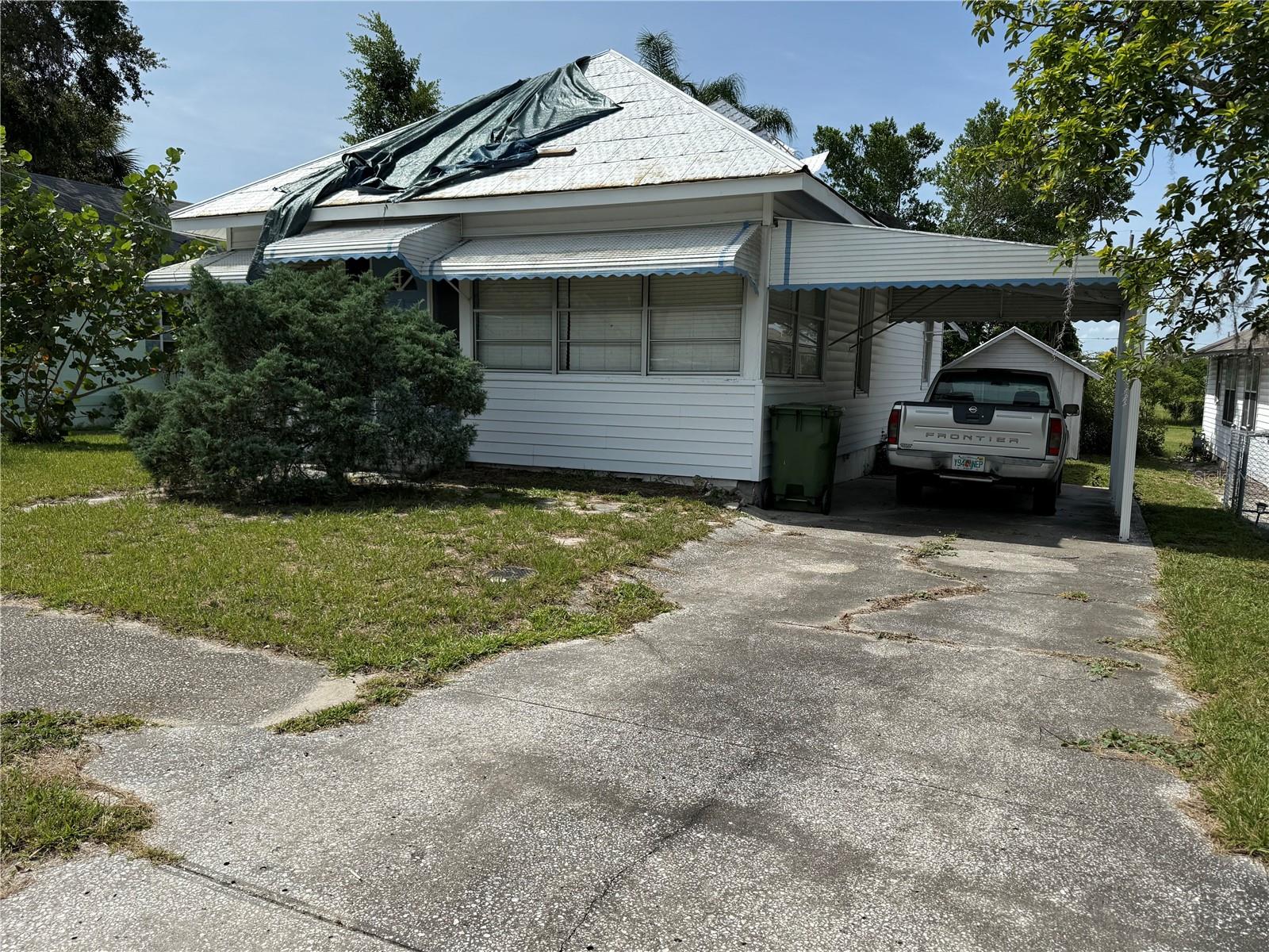 Location, location, location, with house included for under $100,000.00! Near Lake May and Lake Howard and downtown Winter Haven. Second bedroom's closet is located in the dining room. Sold in "AS IS" condition with all contents included. The truck parked in the carport does NOT convey.