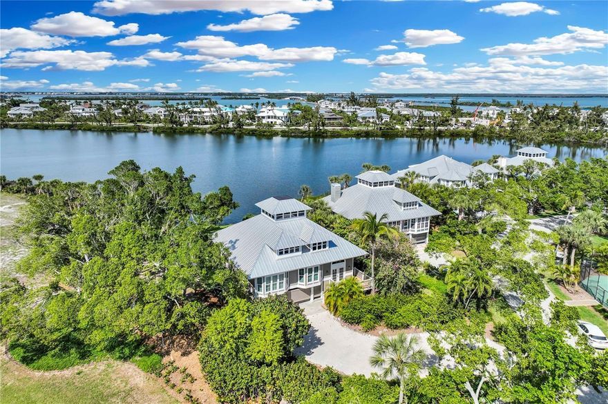 One or more photo(s) has been virtually staged. This waterfront Seawatch residence in Boca Grande offers over 3,000 sq. ft. of living space showcasing stunning views of Lake Gasparilla and its abundant birdlife. This spacious home features three bedrooms, three bathrooms, and multiple bonus areas that could become your office or library. Expansive glass sliding doors lead to a large open porch with unhindered lake views. The eat in kitchen was recently outfitted with new stainless appliances and has plenty of counter space and a roomy pantry. The top floor leads to an en-suite main bedroom with updated bath, a private, open deck, and an upper-level “Seawatch” room. This property has impact, storm rated doors and windows, hardwood floors, updated fixtures and much more. As part of the popular, gated Seawatch community, residents enjoy two pools, three tennis courts, and private beach access to the islands best beach.