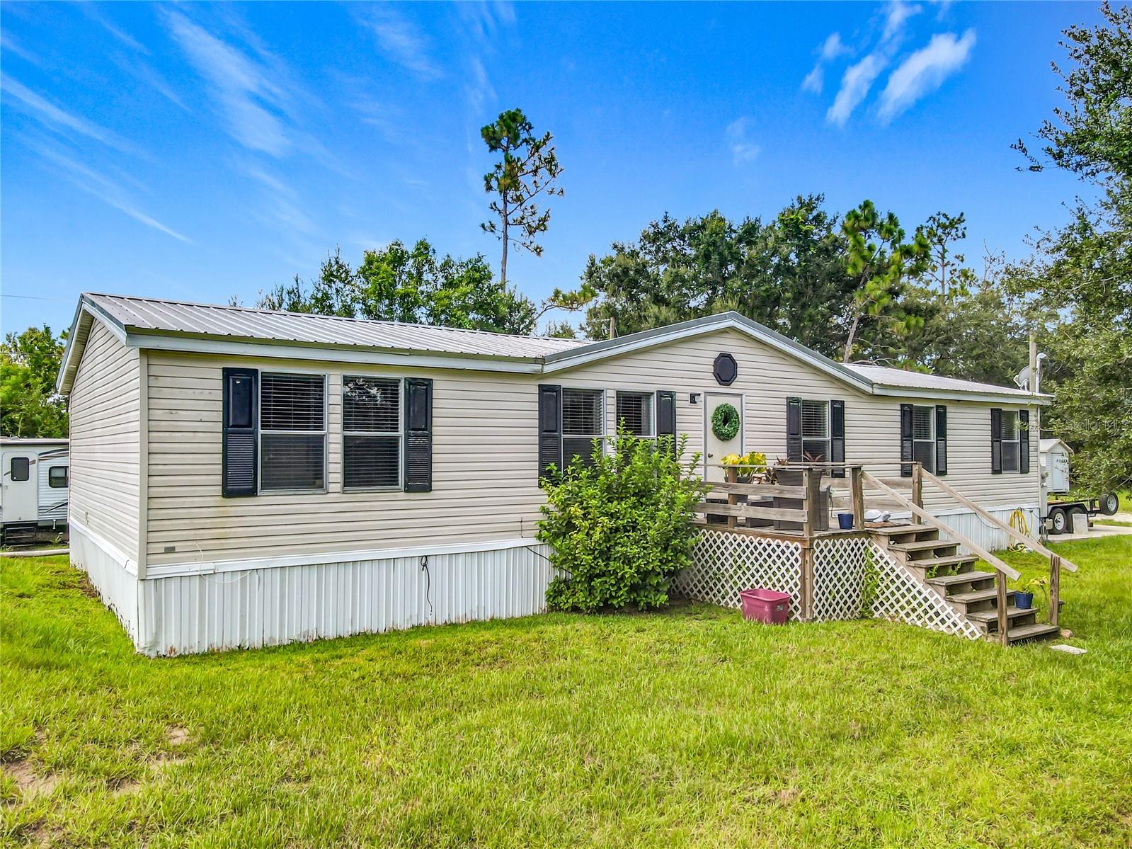 Peaceful country living and space to explore! Welcome to 9300 Concord Rd., a beautifully updated 4-bedroom, 2-bath POOL home on a fully fenced ¾-acre corner lot in desirable Canaveral Acres of St. Cloud with OUTDOOR ENTERTAINING OPTIONS. This move-in ready gem offers a spacious, well-designed layout perfect for both everyday living and entertaining. Inside, you’ll find two separate living rooms with vaulted ceilings, a dedicated dining room and an interior laundry room for added convenience. The living room is located near the front door and offers a spacious space for entertaining, and the family room is located near the sliding glass doors leading to the backyard and offers a fireplace for decorative or potential use. The home’s interior has been tastefully updated and is ready for you to make it your own. Step outside and enjoy the true Florida lifestyle with a sparkling pool, a covered back patio deck, and a converted shed that serves as a charming outdoor entertaining space. There’s also a covered pole barn that was set up as an outdoor kitchen, add your preferred appliances and make this property an entertainer’s dream. Additional features include a durable METAL ROOF, ample outdoor space, and NO HOA, giving you freedom to enjoy your property your way. The property has two matured oak trees and is fully fenced providing privacy and comfort. Ideally located just minutes from St. Cloud, Melbourne, and Orlando International Airport—this unique property offers comfort, space, and style both inside and out. All information is deemed reliable and shall be independently verified. Call today to schedule your tour!