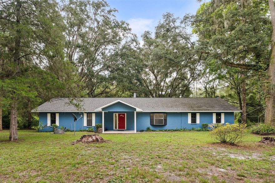 Completely updated concrete-block 4BR / 3BA retreat on 5+lush, canopy-covered acres alive with Florida wildlife such as barred owls, deer, gopher tortoises, wild turkeys and even a shy fox family. You’ll feel worlds away, yet Publix is just minutes up the road and UF Shands is a quick 25-minute drive. Big-ticket items handled: 2022 roof, 2021 HVAC, two new water heaters in 2025. A full-scale 2025 renovation brought luxury wood grain porcelain tiles, 5'' baseboards, fresh interior/exterior paint, new French doors, stylish lighting & fans, three remodeled baths, and a show-stopping kitchen with quartz counters, stainless appliances and deep single-bowl sink. Cozy up to the wood burning fireplace, then step out to your covered and screened back porch, overlooking the expansive property. Turnkey privacy, abundant nature and city convenience. Schedule your tour today!