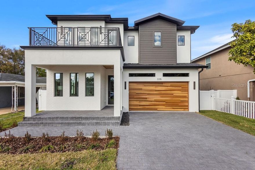 Stunning custom-built modern home in the heart of South Tampa just steps from Midtown offering **3,202 sq ft heated (4,525 total sq ft)** with **4 bedrooms, 3 full baths, 1 half bath, a spacious loft/flex room, and a 2-car garage**. Designed with clean architectural lines and an open-concept layout, this home is ideal for both everyday living and entertaining. The chef’s kitchen features a quartz waterfall island, professional-grade appliances, custom cabinetry, and seamless flow into the living and dining areas. A stylish **wine bar with built-in wine refrigerator** adds the perfect touch for hosting and showcasing your collection. The primary suite offers oversized walk-in closets and a spa-inspired bath with dual vanities and a large walk-in shower. Secondary bedrooms are generously sized, and the upstairs loft/flex space provides versatility for a home office, media room, or play area. Large covered Lani pre-plumbed outdoor kitchen offers endless potential for future upgrades. Built for durability and efficiency, this home features impact windows, 8-foot solid core doors, Level 4 drywall, and spray foam insulation. Engineered hardwood floors add warmth and elegance throughout, while pre-wiring for Cat 6 data and indoor/outdoor speakers ensures modern convenience. Located in Midtown Tampa just minutes from Armature Works, Downtown Tampa, and Raymond James Stadium, this home offers the perfect blend of luxury, comfort, and urban convenience. Don't miss this rare opportunity schedule your private tour today!