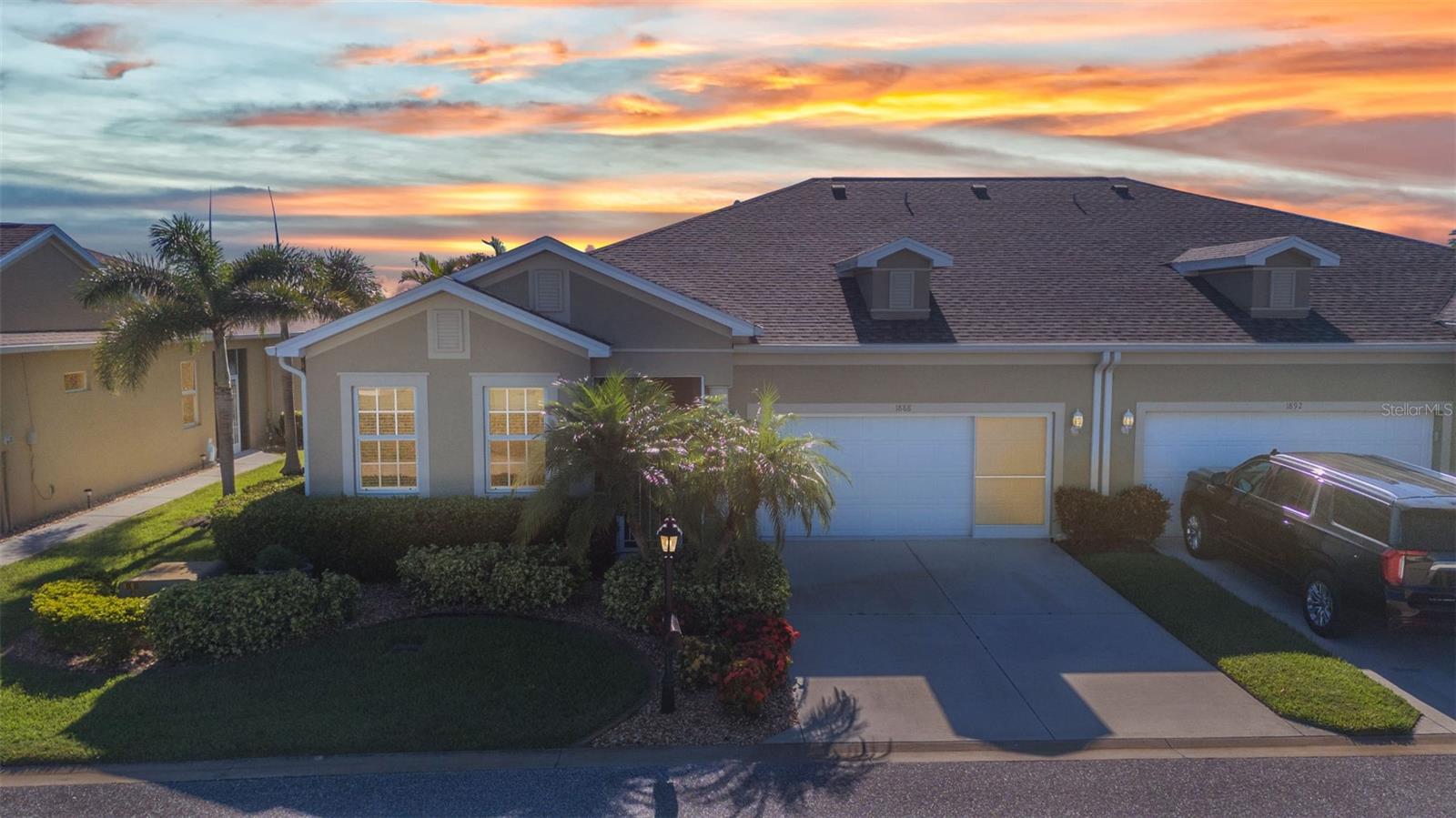 WOW!!!! Massive size villa with AMAZING VIEW and top notch furniture being sold TURNKEY in the gated golf course/active resort of highly desirable Kings Gate, a 55+ community that is NOT in a flood zone and in evacuation zone D (have never been ordered to evacuate). This luxurious feeling villa has a 2022 ROOF and 2023 AC with 2019 HWH. It features impact glass throughout the villa and the lanai is protected by accordion shutters. Ceramic tile in most rooms with the den featuring porcelain tile. Crown molding in living, kitchen and den. Roll in shower in master bath that feature his and her vanities. And the expansive lanai screened-in and enclosed with acrylic windows offers a SENSATIONAL view of the 1st hole, water, and clubhouse. This villa is in an ideal location. Step inside this beauty and you'll notice the tray ceiling with decorative lighting before looking towards the open concept featuring the living room - kitchen - dining room and eventually looking out onto the generous size lanai and that GORGEOUS VIEW. Paver patio just outside lanai - perfect for grilling. Kitchen features corian counters with SS appliances. Garage also upgraded with epoxy floor. Master bedroom is in back right of villa with guest bedroom in front left - offering both you and your guests the desired privacy. And if you haven't been to Kings Gate before - you're going to love the options for activity (Olympic size heated swimming pool and spa, tennis courts, pickle ball, lawn bowling, shuffle board, bocce, horseshoes, gym, billiards, library, euchre, bingo, bridge, Texas hold em, poker, mahjong and more). The onsite AND NEWLY REMODELED Lions Den restaurant and bar is super convenient and also offers Tuesday night Karaoke and monthly trivia contests. Many residents love the fact that they are just a golf cart ride away from the shopping plaza that provides you access to grocery store (ALDI), drug store, bank, restaurants and shopping. Want to explore outside of Kings Gate – you are minutes away from the restaurants and shops of downtown Punta Gorda and Fisherman's village. And if you want to explore more of Florida's fun spots you’re near I75 to quickly head north or south. An AWESOME VILLA with a MILLION dollar view and TOP NOTCH furniture in a PREMIER gated community won't last long. Call today for a private showing and a golf cart tour of the community/amenities.
