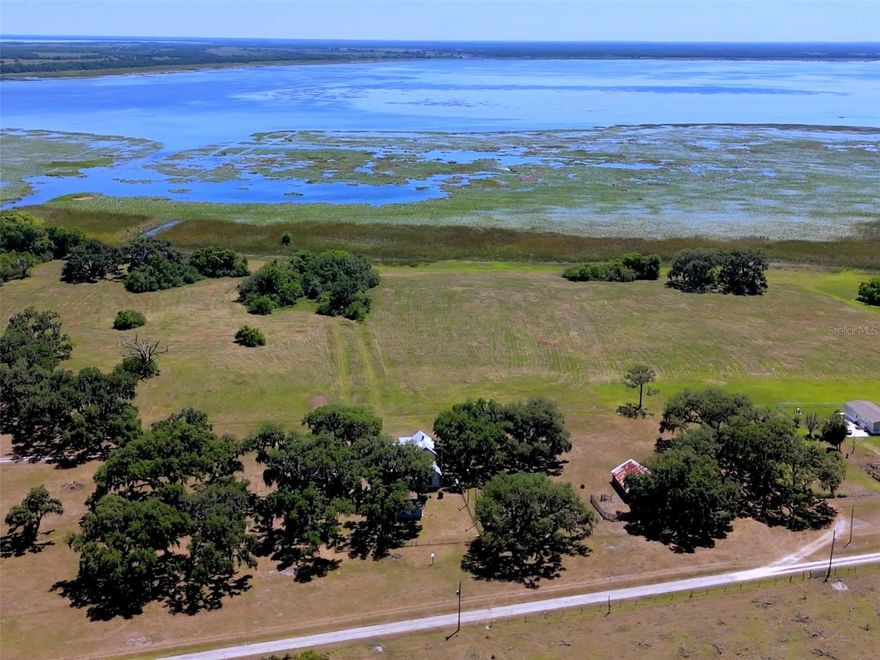 Quite Possibly the BEST LAKEFRONT LOT available in Osceola County, offering 11.3 Acres on Lake Tohopekaliga! The lake covers approximately 20,000 Acres and is about 42 miles in circumference, making ”Big” Lake Tohopekaliga the largest lake in Osceola County and one of the largest lakes in Florida! It boasts some of the best bass fishing in the country - in fact hosting the BassMasters’ tournament and consistently producing record breaking catches. This unique property has 480 linear feet of frontage on “Lake Toho,” beautiful, mature oaks, cleared land, and is currently being used as agricultural - pastureland for cattle. Zoning is Mixed Use, making this particular parcel prime for many types of development ideas. The chain of lakes it is part of includes Lake Tohopekaliga, East Lake Tohopekaliga, Lake Cypress, and Lake Hatchineha, along with other smaller lakes that provide a unique, extensive waterway for a great day of fun on the water. As a bonus, there is an old farm house on the property, with 4 bedrooms and 1 and 1/2 bathrooms, a carport and a shed. Though it is an older home, some of the big items have been replaced in recent years, such as the New Metal Roof in 2011, New Septic in 2005, (cleaned in Feb this year), New Hot Water Heater 2013, and Re-Plumbed in 2007. For the right person, this could be updated to an amazing piece of the local history, or, you might want to live in it while you build your new dream home. There are screened porches upstairs and downstairs, that wrap the front of the home, where you can enjoy the amazing lake view, while relaxing on a rocking chair with your beverage of choice, watching deer, turkey, sandhill cranes, fox squirrels, and of course, if you choose, cattle and horses. The old fashioned “shotgun” style of the home takes full advantage of the breeze off the lake, and provides a flow of nice air through the house. This is a most unique and beautiful property with so many possibilities, that will no doubt prove to be a wise investment in the future.