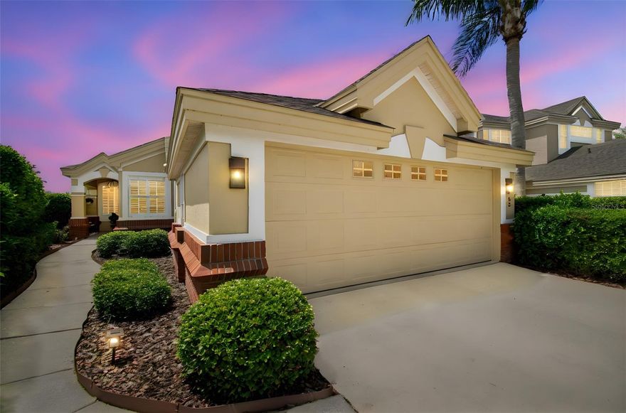 Sitting on nearly a third of an acre, this 3 bedroom 2 bath home on the private Grasslands Golf Club course offers a spacious outdoor area and unobstructed views of the 16th green and 17th fairway. Sit on the large screened-in lanai and take in the scenic beauty while enjoying the gorgeous sunsets and bird life. Grasslands is a gated community with a 24 hour manned entrance. This is a low maintenance home with the association providing yard maintenance (mowing, weeding, trimming, fertilizing, pesticides, monthly irrigation checks (owner responsible if repairs are needed) and exterior painting every 6 years (last done early 2023). Located in the back of a cul-de-sac, this well designed home, full of light, yet very private, has 12 ft. ceilings, double crown molding and plantation shutters throughout. The open concept design is refined with a 3 sided fireplace and mantel between the living and dining areas. The kitchen is spacious with room for an eat in-area and/or center island. There's even an in-floor electrical outlet to accommodate it. Cabinets are custom made with soft close drawers and cabinet doors, Corian countertops, 48" upper cabinets, and pull out shelving in lower cabinets and pantry cabinet. There is also a pantry closet with shelving and a wine cooler. The primary suite is grand with the large bedroom including a seating area with windows and a door for the lanai. Enjoy the elegance and privacy of the primary bathroom area which includes a large custom walk-in closet. Again you will find custom cabinets, Corian countertop, double sinks with new fittings, new lighting, a walk-in shower without a step up or door and plantation shutters for privacy. The second bedroom with its double doors, glass paned with plantation shutters for privacy, is currently being used as an office/den but can easily function as a bedroom. The third bedroom also has a custom-made closet and nice large window. The hall bath has double sinks, linen closet and a private area for the commode and tub/shower. All the ceiling lighting fixtures/fans and the exterior lighting are from 2021. On the way out to the garage there is a laundry room with a sink and full sized LG stackable washer and dryer also 2021. Enjoy the spacious 2 car garage with a refrigerator, 2021, that is included. This is the ultimate place to live. Make it yours!