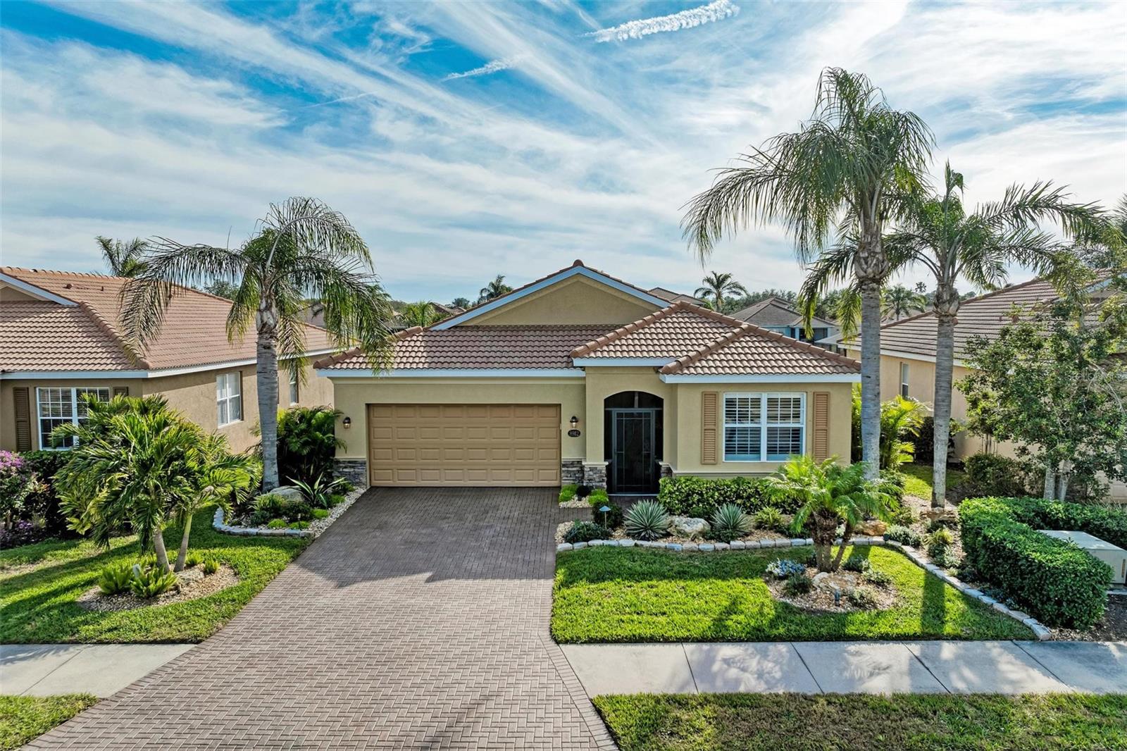 This exquisite residence within River Strand Golf and Country Club seamlessly blends luxury, comfort, and sophisticated design. Boasting a deeded golf membership, this meticulously updated home features an open floor plan with captivating water views and over $180,000 in enhancements. The fully remodeled kitchen showcases custom granite countertops, cabinetry, and top-of-the-line appliances, opening onto a spacious lanai with tailored lighting and privacy shades—an ideal space for both relaxation and entertaining. Additional highlights include a versatile bedroom with a Murphy bed, elegantly redesigned bathrooms offering a spa-like ambiance, and premium finishes such as travertine flooring, plantation shutters, and upgraded HVAC systems.
The garage is a remarkable extension of the home, offering custom rubber flooring, an insulated door, and an air-conditioned space—perfect for use as a home gym or a pristine area to house your vehicles. The exterior of the property is equally impressive, featuring custom landscaping and nightscaping that accentuate the home’s beauty and the surrounding environment.
Beyond the home’s refined interior, River Strand Golf and Country Club offers an unparalleled lifestyle. Residents enjoy access to a newly redesigned Andrew Green 27-hole championship golf course, Har-Tru tennis courts, pickleball facilities, resort-style swimming pools, fitness centers, and a vibrant clubhouse and restaurant/ tiki bar. Ideally located with easy access to I-75, University Town Center, and the area’s pristine beaches, this residence represents the pinnacle of luxury living, offering an extraordinary blend of convenience, elegance, and leisure.