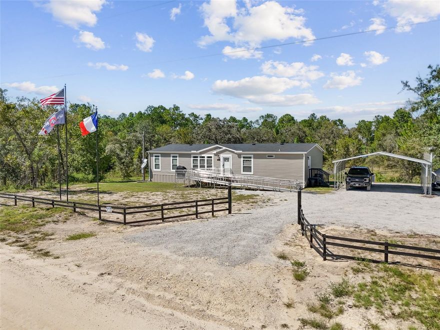 Welcome to your own slice of country living with this practically new 2024 4-bedroom, 2-bath farmhouse-style home! Located on 1.25 acres in Morriston, FL, this Deluxe Tundra model by Live Oak Homes is where quality meets luxury! Spacious and thoughtfully designed, this home comes completely furnished with stylish Ashley brand furniture so you can move right in and start enjoying it from day one. The open layout and farmhouse finishes create a warm, inviting feel, while the primary suite offers a true retreat with a soaking tub, walk-in tiled shower, double vanities, and a generous walk-in closet. At the other end of the home, you’ll find 3 roomy bedrooms along with a second bathroom that also features double vanities for added comfort. Step outside the sliding glass doors to enjoy a 24-foot above-ground pool with a wooden deck perfect for relaxing or entertaining, plus two carports ideal for vehicles or boat storage and two sheds for all your outdoor gear. Tucked away on a quiet country road yet ideally located just 45 minutes to Gainesville and 45 minutes to Ocala, this property blends peaceful rural living with easy access to town—don’t miss the chance to make this turnkey retreat yours today!