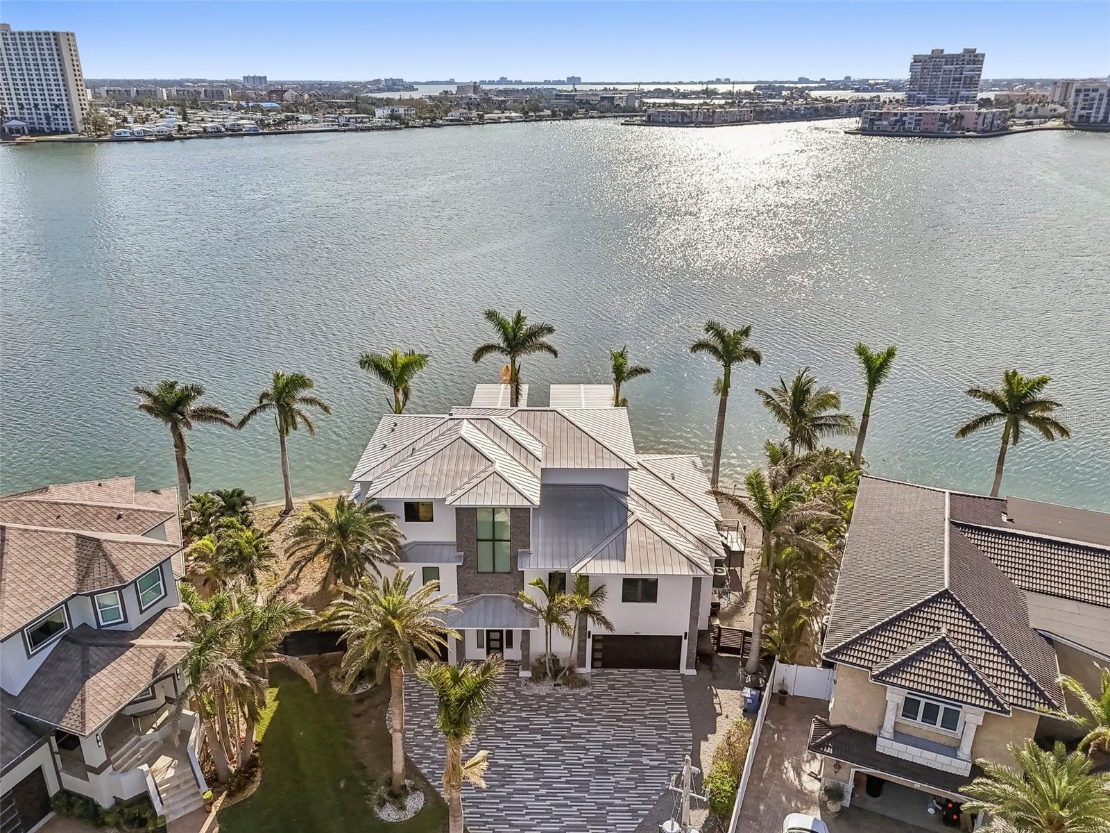 Location, Luxury, Lifestyle – Welcome to Yacht Club Estates
Introducing an extraordinary waterfront residence that blends timeless elegance with modern design in one of St. Petersburg’s most exclusive enclaves. Built in 2019, this exceptional 5-bedroom, 4-bath home is privately positioned at the end of a cul-de-sac on an oversized lot, offering 158 feet of wide open waterfrontage and uninterrupted panoramic views of the Intracoastal Waterway.
Enjoy the peace and privacy of this tranquil setting—tucked away from heavy boat traffic, yet just moments from the best of the Gulf Coast lifestyle. Designed with both luxury and functionality in mind, this home features high ceilings, expansive wall-to-wall sliding doors, and an open-concept floor plan that flows effortlessly between indoor and outdoor living.
The gourmet kitchen is outfitted with a gas range, top-tier appliances, a custom wine cellar, and a massive center island, making it the perfect gathering space for entertaining. Step outside to your private waterfront oasis, complete with a saltwater pool and spa, outdoor kitchen, and outdoor fireplace, ideal for relaxing or entertaining under the stars.
Boaters will appreciate the brand-new composite dock equipped with two high-capacity boat lifts (16,000 & 24,000 lbs) and a dedicated jet ski lift—a rare combination of form and function.
The primary suite is a retreat of its own, featuring a private balcony with dramatic water views, a spa-like en suite bath, and dual walk-in closets.
Every detail of this home was thoughtfully curated the perfect blend of luxury, comfort, and coastal charm. With no HOA, a premier location, and unmatched waterfrontage, this turn-key home represents one of the finest offerings in Yacht Club Estates.
Truly a rare opportunity to own a modern waterfront estate in one of St. Petersburg’s most coveted neighborhoods.