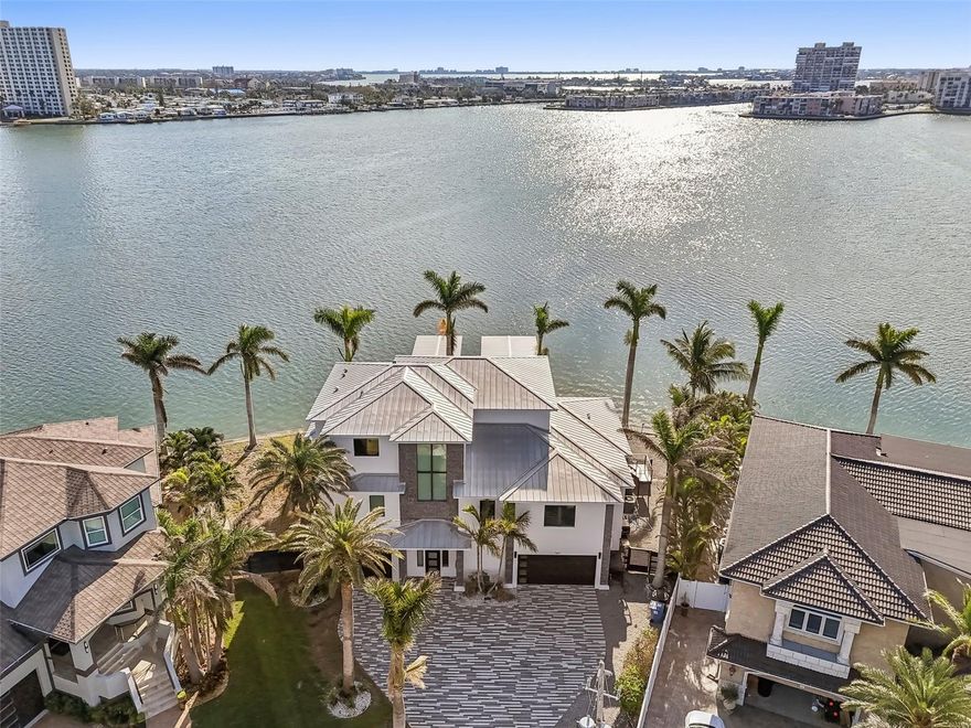 PRICE improvement! Location, Luxury, Lifestyle – Welcome to Yacht Club Estates

Discover an exceptional waterfront masterpiece that seamlessly combines timeless elegance with contemporary design in one of St. Petersburg’s most look for neighborhoods. Built in 2019, this exquisite 5-bedroom, 4-bathroom home is tucked away on an oversized lot at the end of a cul-de-sac, boasting 158 feet of open waterfront and breathtaking panoramic views of the Intracoastal Waterway.

Relish the serenity and privacy of this peaceful retreat—shielded from heavy boat traffic, yet mere moments from the vibrant Gulf Coast lifestyle. Designed with luxury and practicality in mind, the home features soaring ceilings, expansive wall-to-wall sliding doors, and an open-concept layout that transitions effortlessly between indoor and outdoor living spaces.

The gourmet kitchen is a chef’s dream, equipped with a gas range, top-of-the-line appliances, a custom wine cellar, and a spacious center island, perfect for hosting gatherings. Step into your private waterfront paradise, complete with a saltwater pool and spa, outdoor kitchen, and fireplace, ideal for relaxing or entertaining under the night sky.

Boaters will delight in the brand-new composite dock, featuring two high-capacity boat lifts (16,000 & 24,000 lbs) and a dedicated jet ski lift—a rare blend of style and functionality.

The primary suite is a private haven, offering a secluded balcony with stunning water views, a spa-inspired en suite bathroom, and dual walk-in closets.

Every aspect of this home has been meticulously designed, embodying the perfect balance of luxury, comfort, and coastal charm. With no HOA, a prime location, and unparalleled waterfront access, this turnkey residence is among the finest available in Yacht Club Estates.

An extraordinary opportunity to own a modern waterfront estate in one of St. Petersburg’s most sought-after communities.
