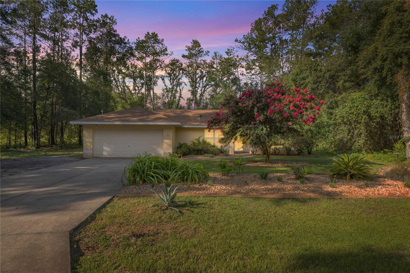 One or more photo(s) has been virtually staged. Welcome to this beautifully maintained 3-bedroom, 2-bathroom home offering just under 1,700 square feet of comfortable living space, nestled on a .23-acre lot in a peaceful, tree-lined setting. Built in 2007, this home has been thoughtfully updated with major improvements including a new roof (2022), new AC unit (2021) with semi-annual maintenance, and a generator hookup added in 2023—providing you with peace of mind for years to come. Curb appeal is top-notch with professionally designed landscaping, eye-catching pavers, and a warm and inviting aesthetic that feels cozy the moment you arrive. The irrigation system ensures your yard stays picture-perfect with minimal effort. Step inside to find vaulted ceilings that create an open and airy feel throughout the main living areas. The primary suite offers a walk-in closet and a shower/tub combo, while the guest rooms have been updated with new luxury vinyl and stylish flooring. One of the standout features of this home is the large Florida room, enclosed with glass windows—ideal for relaxing with your morning coffee or entertaining guests year-round. Additional upgrades include a whole-home purifying salt system and a hot water heater that’s just one year old.
Situated on a quiet and private road surrounded by mature trees, this property combines the best of low-maintenance living with a serene atmosphere. If you’re looking for an affordable, move-in ready home with privacy, curb appeal, and smart upgrades, this one checks all the boxes!