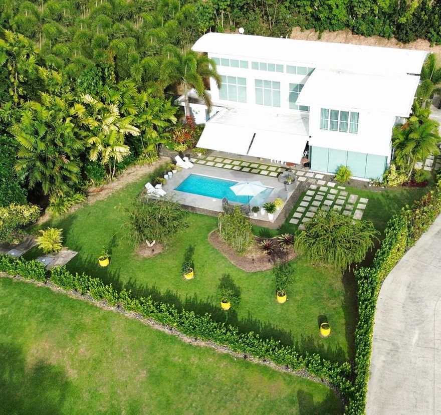 One or more photo(s) has been virtually staged. Impressive estate located in Mountain View, Lomas del Sol, Guaynabo. This residence offers 3,588 sqft of construction, enhanced by over 2,200 sqft of terraces and patios, featuring 5 bedrooms and 5 bathrooms designed with both comfort and style in mind. It also includes a detached gazebo with its own BBQ, for added convenience. This home combines modern elegance with comfort, highlighted by showcasing a resort-inspired pool surrounded by lush tropical landscaping. Key amenities include an indoor/outdoor entertainer's kitchen, gated parking for up to 6 vehicles, a 15kW generator with 6-day autonomy, a 600-gallon cistern, enterprise-grade fiber internet with full Wi-Fi coverage. The property is only minutes from expreso Martínez Nadal and Guaynabo’s private schools and a police station.