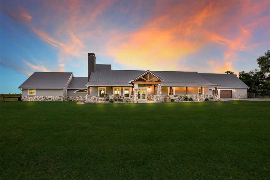 Welcome to an extraordinary private estate set on 80 pristine acres in the heart of Myakka City, just moments from the exclusive Soleta Golf Club. Framed by a grand canopy of mature oak trees, this custom-built residence offers a rare blend of refined luxury and serene countryside living. Spanning an impressive footprint, the home features five generously appointed bedrooms and six elegant bathrooms, thoughtfully designed for both elevated comfort and effortless entertaining. The primary suite serves as a true retreat, complete with a spa-inspired ensuite showcasing dual vanities, separate water closets, and expansive dual walk-in closets. A dedicated media lounge—ideal as a private theatre, game room, or fitness studio—enhances the home’s lifestyle appeal. Crafted with enduring block construction and crowned by a sophisticated metal roof, the residence exudes both timeless beauty and lasting quality. At the heart of the home, the gourmet kitchen is a chef’s showpiece, featuring granite surfaces, an oversized island with dual sinks, a farmhouse apron sink, and a professional-grade six-burner Wolf gas range with griddle and hood. The open-concept design flows seamlessly into the dining and living spaces, where engineered hardwood floors and a gas fireplace with designer tile surround create an inviting yet upscale ambiance. Outdoors, a resort-style oasis awaits. The striking 50' x 24' custom pool is perfectly positioned to capture sweeping views of the surrounding landscape and is complemented by integrated outdoor audio and a gas connection for al fresco entertaining. Beyond, the estate reveals a picturesque four-acre pond and a private 300-yard shooting range, offering a unique blend of recreation and tranquility. Designed with versatility in mind, each bedroom enjoys its own ensuite bath and ceiling fan for ultimate privacy. The property also includes a private interior studio apartment, as well as a full guest residence above the garage—complete with its own kitchen, living area, and a newly upgraded Trex deck overlooking the pool. With no deed restrictions or HOA, this exceptional property offers complete freedom to embrace a luxury rural lifestyle, whether accommodating livestock or simply enjoying the expansive grounds. A gated entrance ensures both privacy and security, while convenient access to Interstate 75 and Lakewood Ranch places world-class amenities within easy reach. This is more than a home—it’s a legacy estate where elegance, space, and lifestyle converge.