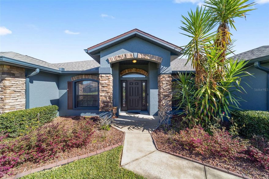 Located in the desirable gated community of The Arbors in Southeast Ocala, this elegant single-family home offers space, comfort, and quality construction on a generous ¾-acre homesite. Built in 2006, the residence features 5 bedrooms, 3 bathrooms, and approximately 2,737 square feet of living space, providing ample room for both everyday living and entertaining.

The home showcases concrete block construction with stucco and stacked-stone accents, creating attractive curb appeal and durable Florida architecture. Inside, the interior features real cherry hardwood floors, vaulted ceilings, crown molding, and an open floor plan designed for modern living.
