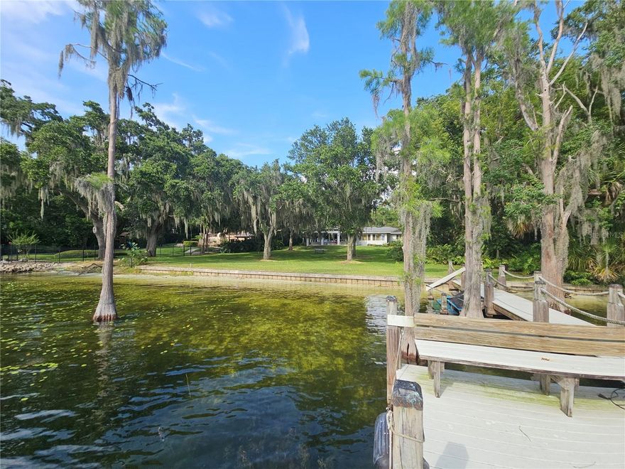 Amazing opportunity having over 125 feet of shoreline on Lake Butler of the famed Butler Chain of Lakes - Over 1 acre of dry land having over 342 feet - Huge 45 x 31 - 4 Car Garage that can double as a detached Inlaw Apartment with a private entrance - Main 1 Story Home is over 3,400 sq ft - Very Rare Fully Enclosed Boathouse that is grandfathered in - Seawall - Crystal Clear Water - White Sand Beach - Large Oak Trees