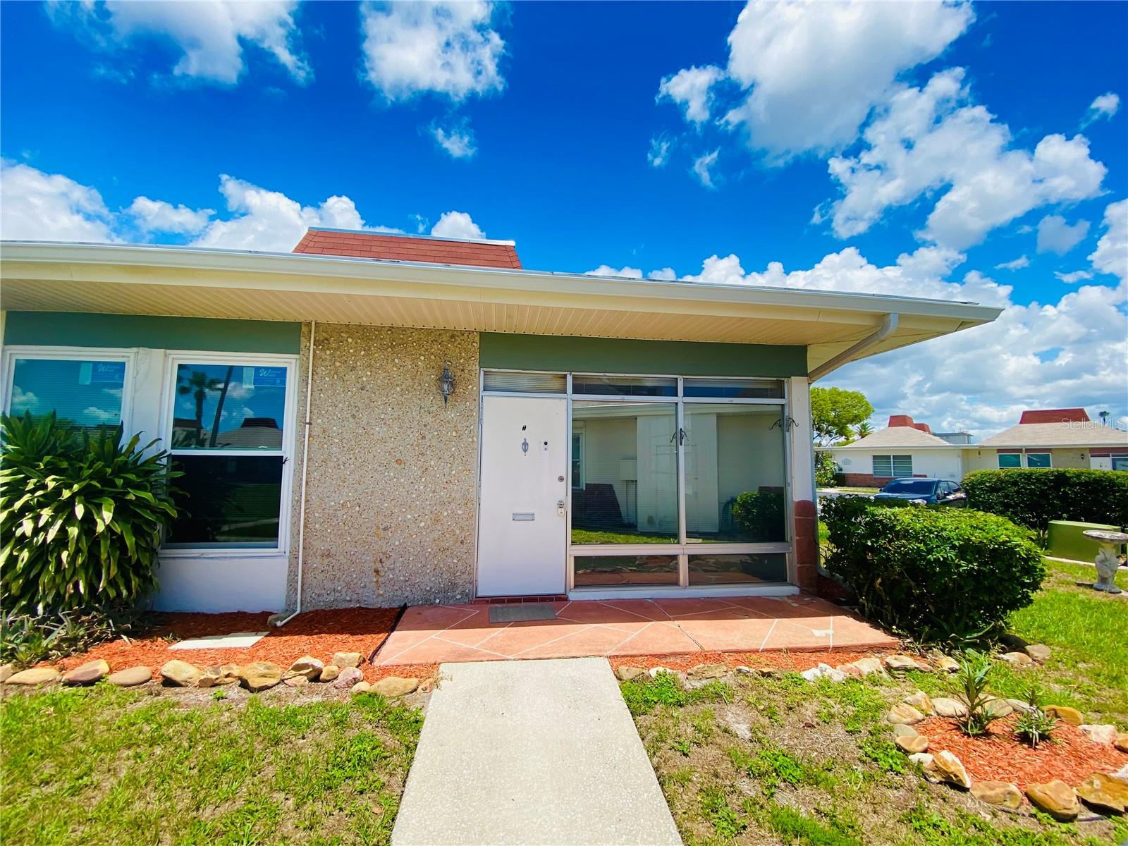 Beautiful corner unit. This unit is a 2 bedroom 1 bathroom, the primary room offers a walk in closet. Located in the highly desirable gated 55+ community of Tahitian Gardens. This rarely available corner unit offers enhanced privacy, peaceful views, and direct access to the community's scenic walking path ideal for enjoying Florida's tranquil lifestyle. Enjoy your morning coffee or evening breeze from your private front patio area. Whether you're downsizing, looking for a seasonal residence, or seeking a low-maintenance lifestyle, this move-in ready villa is an excellent choice. Tahitian Gardens offers an abundance of resort-style amenities including a heated swimming pool, shuffleboard, clubhouse, and an active calendar of social events. Conveniently located near shopping, dining, public transportation, and just minutes from the Gulf beaches, the Sponge Docks, and everything Tarpon Springs has to offer.