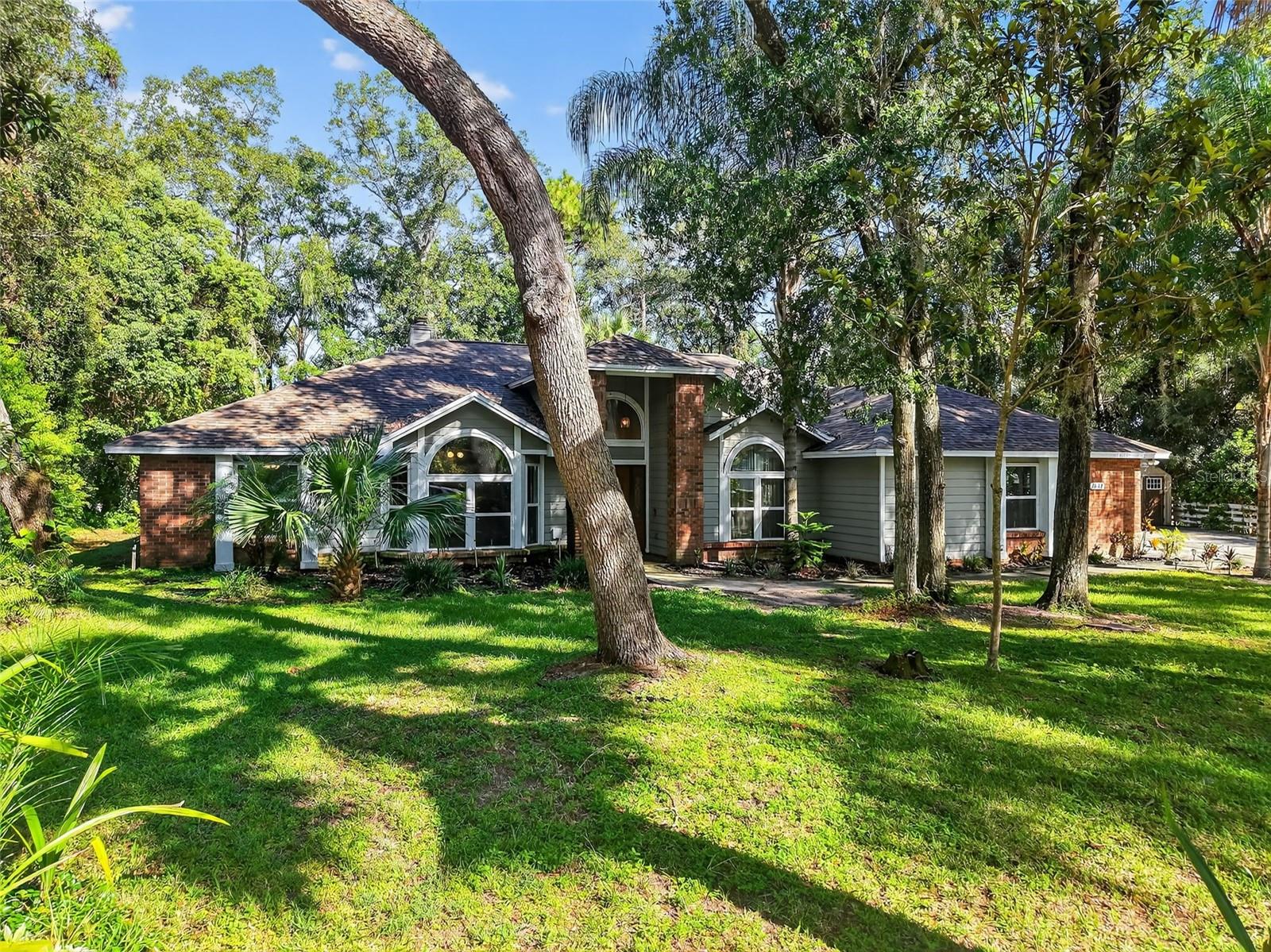 Come home to this spacious pool retreat in sought-after Errol Estates, perfectly situated on over half an acre! Featuring 4 bedrooms, 2.5 baths, plus a versatile study/den, this home offers plenty of space for family, guests, or hobbies. Tucked away on a quiet cul-de-sac with a side-entry garage, you’ll enjoy the serenity of the neighborhood while still being close to restaurants, shopping, schools, the hospital, and quick access to the Turnpike for an easy drive to Orlando, area theme parks, or the airport. Step inside through the beautiful leaded-glass front door and into the welcoming foyer. To the left, a light-filled den; to the right, a formal dining room — both showcasing large windows that fill the home with natural light. High cathedral ceilings create an airy feel throughout. The spacious living room, anchored by a cozy wood-burning stone fireplace, flows seamlessly into the kitchen and breakfast nook. The kitchen features granite countertops, a breakfast bar, and brand-new appliances. Large sliding glass doors open to your private outdoor oasis - a sparkling pool with fountains, ideal for both sun and shade lovers. Whether dining, entertaining friends, or simply relaxing with a cool beverage, this backyard was made for year-round enjoyment. The primary suite offers direct pool access, a walk-in closet, and a spacious ensuite with dual showers. A thoughtful split floor plan provides additional privacy, with one bedroom and a half bath on one side of the home where the primary is, and two more bedrooms plus a full pool bath on the other side. Additional highlights include new energy-efficient windows and sliders, ceiling fans throughout, a 2022 roof, and a 2017 water heater. This home combines comfort, function, and style - all in one of Apopka’s most desirable communities!