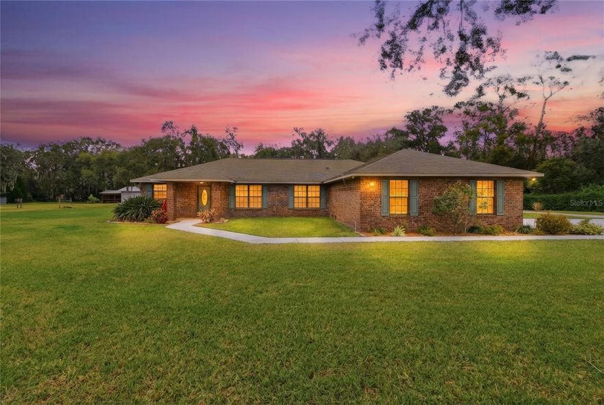 OWNER FINANCING AVAILABLE! Short-term OR Long-term options. Welcome to your private estate! This beautifully maintained 4-bedroom, 2-bath estate sits on 4 tree-lined acres with a charming creek flowing along the back of the property. The classic brick exterior is both timeless and low maintenance, while the interior offers a spacious split floorplan designed for comfort and entertaining. Kick off your shoes in the expansive Florida room overlooking a screen-enclosed saltwater pool, surrounded by elegant pavers and mature landscaping. RV, Boat, Camper, Tractor, Equipment? This property has all your needs covered! TWO metal barns, a pole barn, and a detached garage—ideal for storage, workshops, or creative space. Mature oak trees provide shade and beauty throughout the property, creating a peaceful and quaint setting. Whether you're looking for a forever home or a weekend escape, this one-of-a-kind estate offers the perfect blend of comfort, space, privacy, and outdoor beauty with endless opportunities.