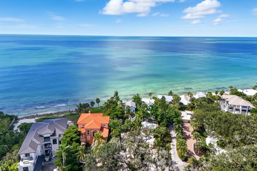 A rare Gulf-front property on Siesta Key’s legendary Point of Rocks—one of Sarasota’s most coveted and geologically unique coastal settings. Perched above the shoreline on ancient limestone formations estimated to be over 3,000 years old, this elevated homesite captures breathtaking, unobstructed views of the Gulf and spectacular nightly sunsets. Set on over one-third of an acre, the existing structure features 4 bedrooms and 4 bathrooms across a spacious split-level design with multiple indoor and outdoor living areas with flexible layouts—perfect for entertaining or relaxing in total privacy. The surrounding waters are alive with sea life and ideal for swimming, snorkeling, kayaking, or paddleboarding right from your backyard. What truly sets this property apart is its existing building footprint—a rare advantage that may allow rebuilding much closer to the water than current regulations permit for new construction. This positioning maximizes the site’s potential and preserves unmatched Gulf views. Whether you renovate, expand, or create a modern coastal retreat within the footprint, the possibilities are extraordinary. With such a large private setting, an entirely new estate could easily be designed. Just a short stroll, golf cart, or bike ride brings you to Crescent Beach and the vibrant shops and restaurants of Crescent Village. With its rare proximity to the Gulf, elevated Point of Rocks location, and limitless potential, this is one of Sarasota’s most unique and coveted Gulf-front offerings.
