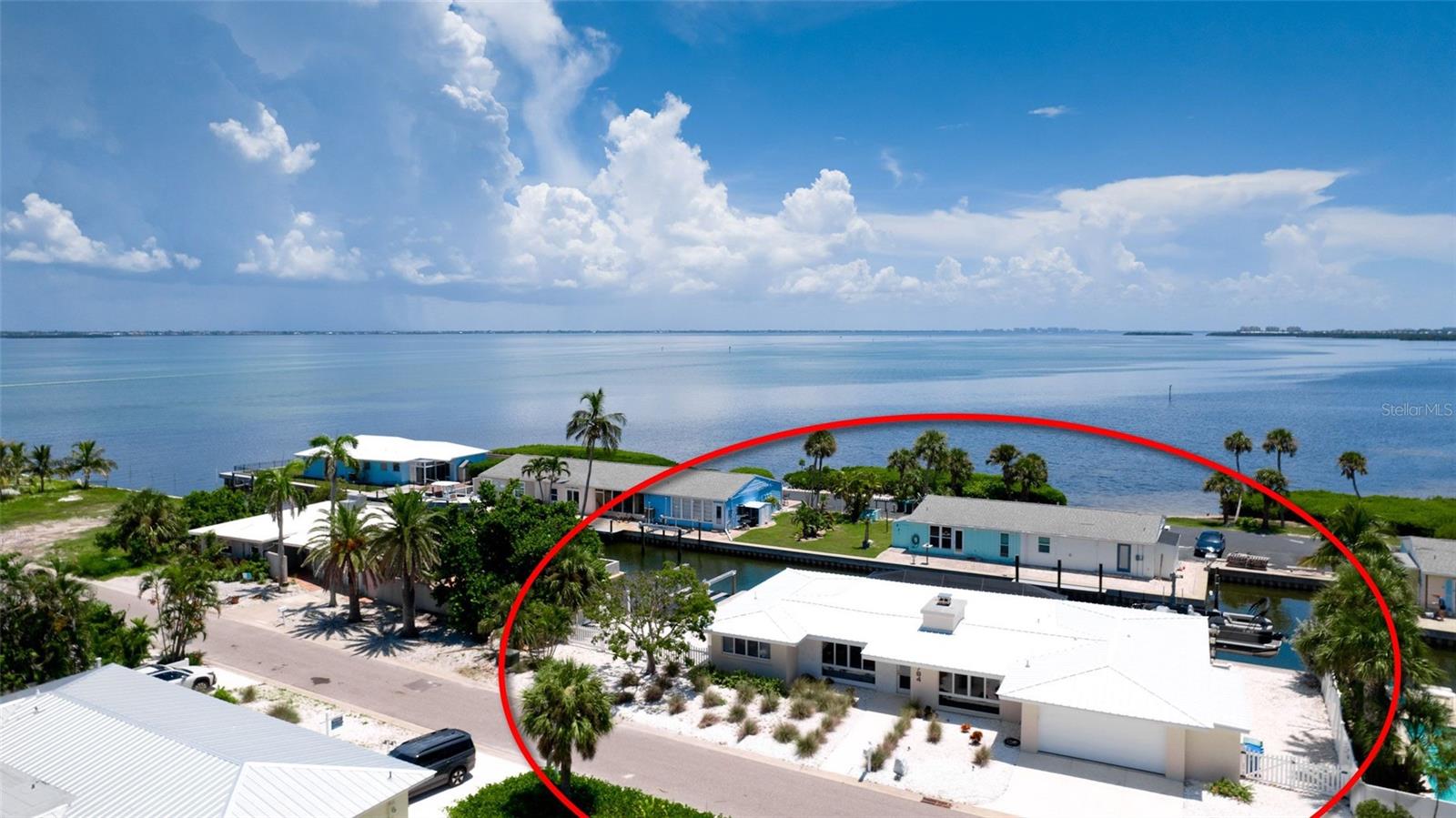 Enjoy all that living on the water includes from this location. This canal pool home with its 2 remote controlled boat lifts, its southern exposure, is where you could love to call home. Quality is apparent from the first time you gain entry to this charming Florida lifestyle residence on Longboat Key. The character of the original home with its vaulted wood beamed ceilings and stone fireplace have been complemented by modern touches of Shellcrete concrete walkways, pool deck and driveway. A nice blend of functionality, original character and modern upgrades make this home an attractive waterfront living option. Easy access from the canal to the Sarasota Bay and downtown Sarasota. A great opportunity for Island living.