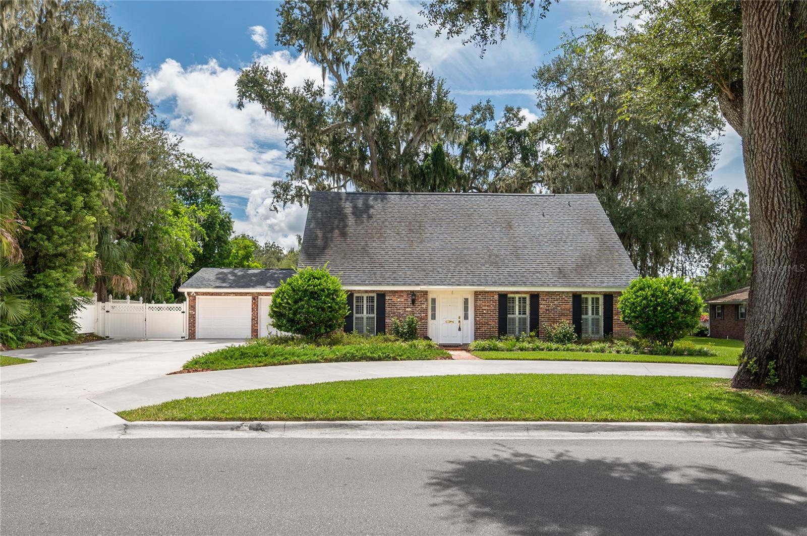 This beautiful red brick two-story home is the perfect blend of traditional architecture with modern updates and conveniences providing an exceptional opportunity to live in style and comfort. Step into the entry foyer to a wonderful, flowing downstairs layout. Your family will enjoy having their own space with 3 distinct living spaces with each having double entryways, creating a natural flow of openness --- living room, family room with a beautiful wood burning fireplace, and a 33' long Florida room. French doors lead from both the kitchen and family room to the huge Florida room full of ambience with brick floors, serving cabinetry, and an abundance of windows to enjoy the beautiful backyard. A lovely dining room that worked perfectly for a home office for the current owners. The heart of the home may be the gorgeous, updated kitchen complete with a large center island, stainless steel appliances, an abundance of cabinetry with pristine quartz countertops, and a convenient pantry. The primary suite features a walk-in closet and lovely updated bath with double lavatories. Two full baths and two half baths add to convenience for your family. The outdoor living space is equally impressive with a large brick patio that is ideal for entertaining, mature landscaping with full lawn irrigation, additional boat/vehicle parking behind the vinyl double gate, and a garden/storage shed, or kennel. A double garage, circular drive, and an extra wide driveway lends to ample parking. Your family will love the flexible space in this home to suit your family's needs. No HOA!
