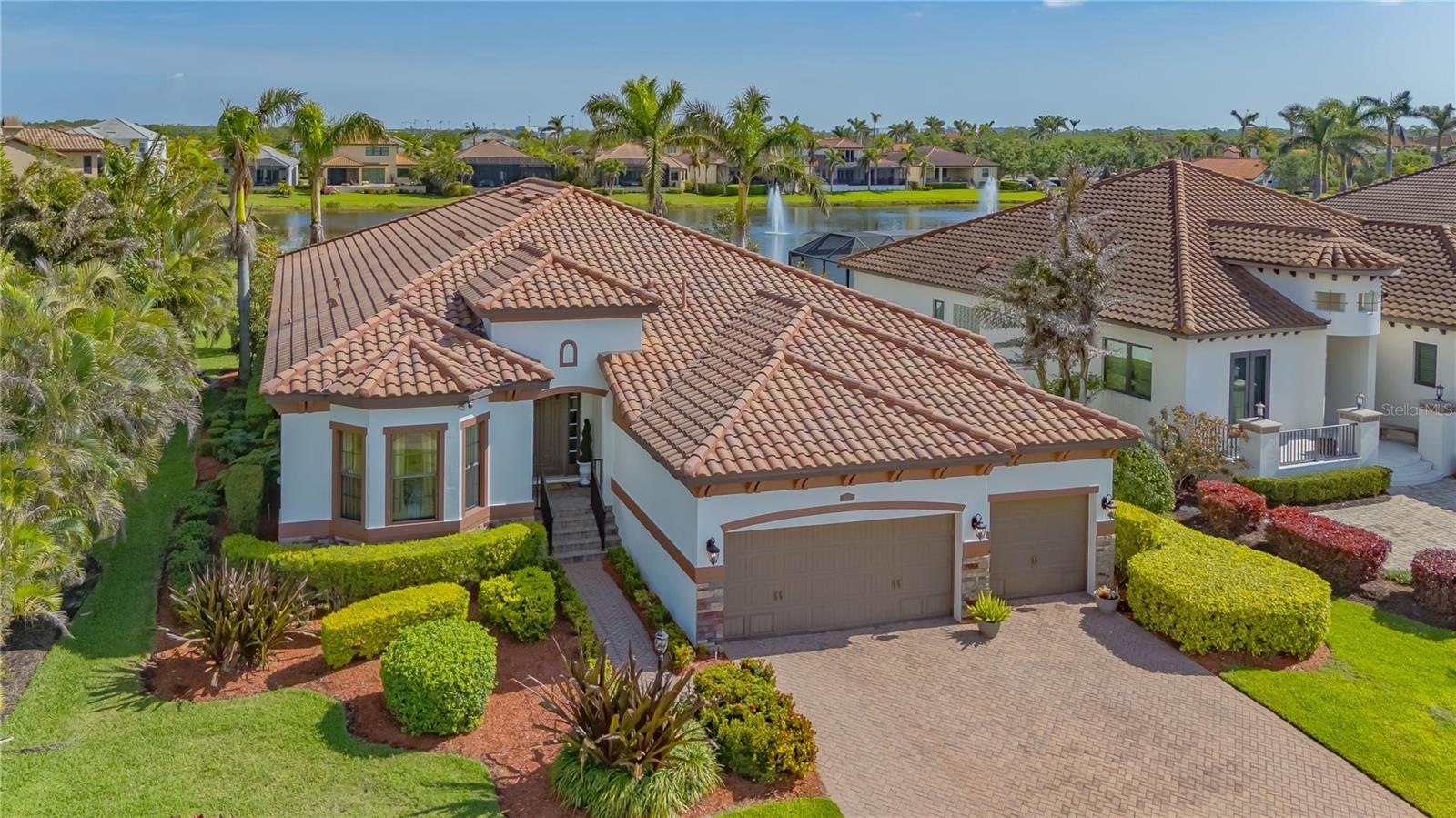 This Stunning 4-Bedroom, 3 1/2 -Bath home, with over 4300 sq. ft. under roof, has been completely remodeled with exquisite designer finishes throughout. Featuring upgraded light fixtures, high-end details, and 10' 4'' ceilings, this immaculate home will Not disappoint! This custom One Story floorplan seamlessly flows to an expansive screened lanai, offering the perfect blend of indoor/outdoor space. The lake views are amazing and there is room to add a pool. The Kitchen has been completely renovated and features luxurious Quartzite countertops, a waterfall kitchen island, 5 burner Gas range, upgraded hardware and a breakfast bar. A cozy nook between the kitchen and the family room provides beautiful views of the lake through two luxury windows. The home has a split floorplan with spacious guest bedrooms providing privacy and comfort for family or friends. The luxury laundry room offers ample storage space, making organization a breeze. The bonus 3-car garage also includes plenty of room for storage. Recent updates include, total repainting of exterior and interior, a new A/C system (warranty included), new garage door, new microwave and new designer walls in the primary bathroom. The home is set on an oversized lot in the premier location of Legend's Bay. Amenities are right around the corner and include a heated pool, a clubhouse, a catering kitchen and a scenic nature walking pier that overlooks Sarasota Bay. Located in a gated community, this home is just minutes from IMG academy, beaches, SRQ airport, and the vibrant downtown Sarasota and Bradenton areas.