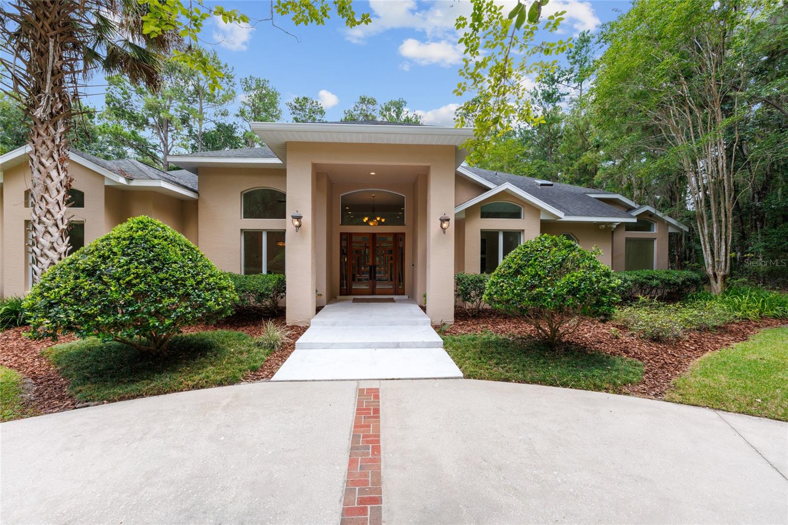Architectural Masterpiece in Gated Ocala Community –
This extraordinary one-story estate offers 4 bedrooms + office, 5.5 baths, and over 4,500 sq ft of refined living space on nearly 4 private acres. A true modern sanctuary, the home has been completely redesigned with imported marble slabs from Greece flowing throughout, and floor-to-ceiling marble in every bathroom—each showcasing custom design and spa-quality finishes.
The sleek, state-of-the-art kitchen features Gaggenau & SubZero appliances, custom stainless steel cabinetry with lacquer doors, stainless counters, and a minimalist aesthetic rarely seen in Central Florida. Each bedroom includes bespoke wardrobe closets, while the laundry room continues the high-end motif with stainless cabinetry and finishes.
Luxury abounds in the bathrooms with Graff, DornBracht, Axor, Porcelanosa, and Rubinetterie Treemme fixtures, smart toilets, privacy glass, and mirror-integrated to set up TVs in the primary bath. The soaking tub is set against a breathtaking 10-ft onyx wall—a signature statement piece.
Gather in the living room around the remote-controlled 12-ft book matched onyx fireplace, or step outside to an entertainer’s paradise: a heated pool, two pergolas with motorized retractable roofs & blinds, and a 722 sqft glass-enclosed lanai overlooking lush surroundings.
Additional features include:
Remote-controlled ethanol fireplace
Full home security with camera system
AC’d garage/gym, 2025 AC + 2 additional systems
Roof (2012), pool deck (2018), exterior paint (2015)
Every room offers curated luxury and privacy—with serene views and top-tier finishes at every turn. Ready to fall in love?
Let’s walk this property together—schedule your private tour today.