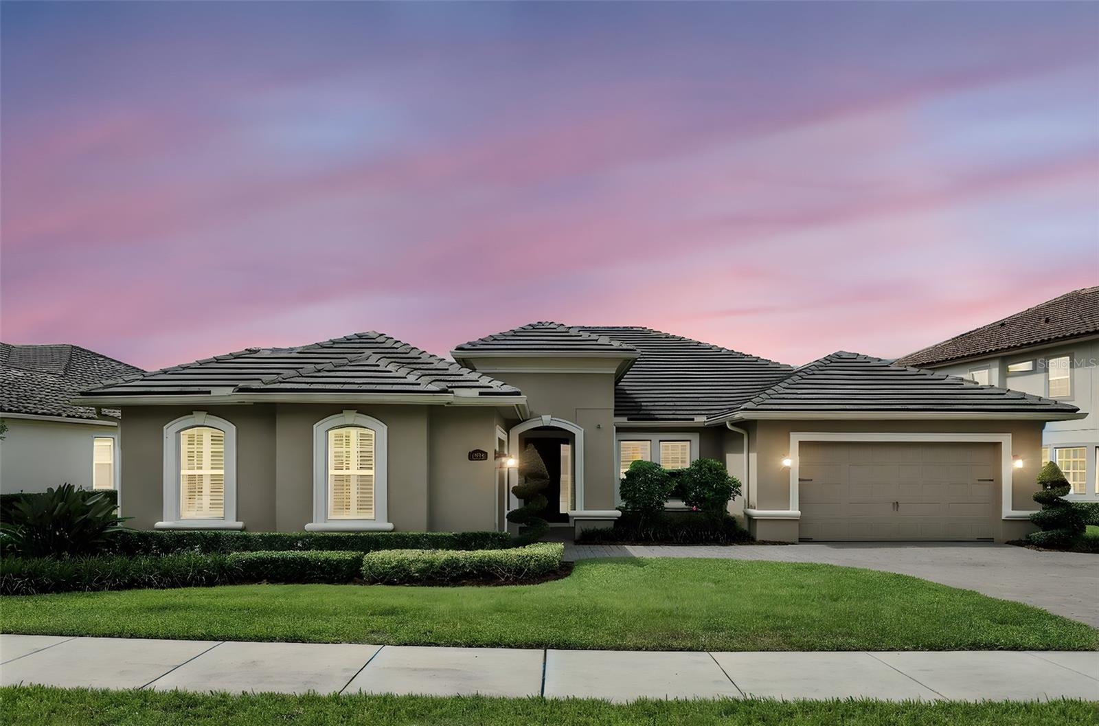 Welcome to this IMPRESSIVE WATERFRONT single-family home, impeccably ready for you to move in, nestled in one of the most sought-after elite luxury gated community of Steeple Chase, in the heart of Lake Mary, Florida. This community boasts 142 residences, enveloped by lush trees, tranquil lakes, and direct access to the Seminole Wekiva Scenic Trail—perfect for walking, jogging, and biking. The "Cordova" model from Taylor Morrison offers a flawless mix of luxury and comfort with 4 generously sized bedrooms, 3 elegantly crafted bathrooms, an office/den with custom maple wood built-ins and a granite-topped workspace, and a 3-car garage, offering 3,286 square feet of living space. As you enter through the main door, you are welcomed by an expansive foyer filled with natural light, highlighting a breathtaking water view. This home is loaded with remarkable upgrades that must be seen to be appreciated! It features premium tile flooring throughout, upscale lighting, custom wood plantation shutters, a large, motorized roller shade on the living room sliders, tray ceilings, crown molding, and personalized closets in every bedroom, among many other upgrades. While the Cordova model boasts an open floor plan, it still provides distinct spaces for formal living and dining, as well as a specific office area. At the heart of the home, a stunning gourmet kitchen beckons, crafted for culinary enthusiasts with top-tier finishes. It includes dual islands with eye catching stone countertops—one offering seating—and upgraded 42” espresso cabinetry. High-end stainless steel GE Monogram appliances include a built-in refrigerator, a built-in microwave oven, a microwave/convection combo, a vented range, an energy star dishwasher, and a 5-burner gas cooktop. The spa-inspired owner's suite features a lavish en-suite bathroom, separate walk-in closets with custom shelving and drawers, a tub, a separate walk-in shower, and dual split vanities that are sure to impress. Three additional generously sized guest suites ensure comfort and privacy for family or visitors. If entertaining is your passion, step out to your private oasis offering sweeping water views and revel in a sparkling saltwater screened-in pool equipped with a natural gas heater. The outdoor kitchen is ready for culinary feats, outfitted with a built-in grill, griddle, drawers, and a dual motor exhaust fan with a glass block back wall, rendering this outdoor space ideal for weekend gatherings and poolside entertaining. Prioritizing energy efficiency, the home includes a tankless gas water heater and double-pane windows to enhance energy conservation. Meticulously maintained, this property offers everything necessary for a luxurious lifestyle. Steeple Chase stands out as an elegant community with contemporary features; it's conveniently close to exquisite dining, shopping & entertainment options in Lake Mary. You’ll enjoy swift access to the I-4, 417 & 429 highways as well as top-rated Seminole County schools. A short drive will take you to Downtown Orlando, Disney parks, or the sunny shores of the Atlantic Ocean beaches. This home is a must see!! Seize the opportunity to own this slice of paradise in Lake Mary by scheduling your private tour today! This incredible home comes with a one-year home warranty for complete peace of mind. Note: Audio/visual surveillance may be present on this property.