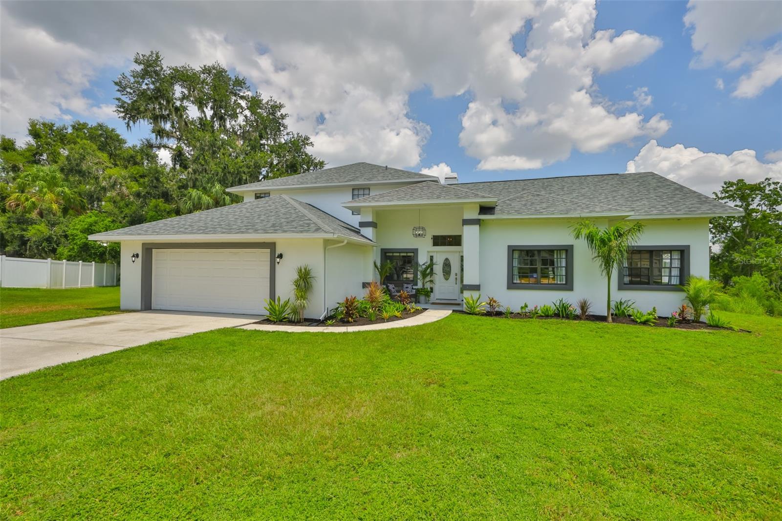 Tucked away at the end of a quiet cul-de-sac in Hickory Lake Manor, this stunning 5-bedroom, 3-bath, 2-car garage home offers luxury living with breathtaking views and direct access to a 40-acre lake. The home features a new roof (2025), a water heater (2022), and a thoughtfully designed floor plan with the primary suite on the first floor, complete with en suite bathroom with dual sinks, large soaking tuband quartz countertops. Two additional bedrooms and a full pool bath are also on the main level. The kitchen is outfitted with quartz countertops, stainless steel appliances, a dinette, and a formal dining room. A wood-burning fireplace anchors the living room, and sliding glass doors open to a spacious lanai with a screened in pool and spa overlooking the lake. Upstairs includes a huge loft perfect for a media room or game room, two more bedrooms, and a bathroom with dual sinks, perfect for flexible living. With tons of storage throughout and an easy commute to Downtown Tampa, Tampa International Airport, MacDill Air Force Base, Plant City, Riverview, shopping, and dining, this lakefront retreat is the perfect place to call home. Call today for your private showing!