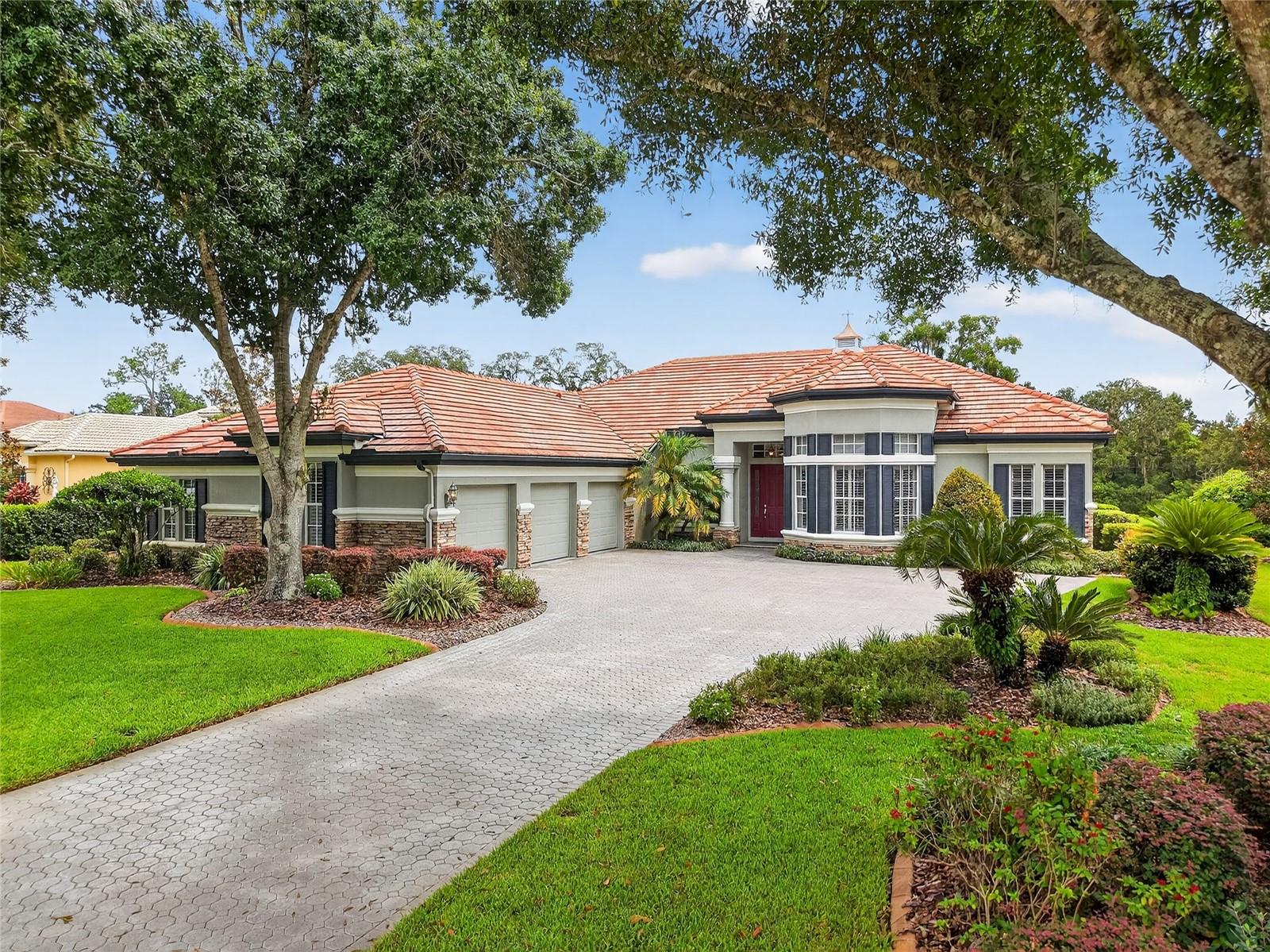 Welcome to Lake Jovita & Country Club. A lifestyle of elegance surrounded by East Pasco’s rolling hills. This pristine 3,540 sq ft residence has been lovingly maintained and thoughtfully upgraded, presenting itself as a showpiece home that feels timeless and new. With no CDD fees, this estate is as practical as it is luxurious. From the moment you enter, your eyes are drawn upward to soaring ceilings with simulated skylights, guiding your gaze out toward the tranquil pool and sweeping golf course views. Expansive sliding glass doors seamlessly tuck away into the wall, extending your living space outdoors to an oversized lanai and pool deck. The perfect setting for morning coffee at sunrise or evening gatherings at sunset. The executive office offers custom built-ins, a generous desk, and a private sitting area, ideal for working or hosting intimate meetings. The primary suite is a true retreat, with a private hallway, dual custom walk-in closets, and a spacious bedroom that easily accommodates a sitting area overlooking serene golf views. The spa-like en suite features dual vanities, a walk-in shower, and thoughtfully designed storage. The chef’s kitchen boasts Cambria Brittanicca quartz countertops, designer cabinetry with pull-out shelving, a diamond under-mount sink, and lighting that enhances both function and ambiance. A wall of windows in the breakfast nook frames postcard-worthy views of the pool and golf course. Guest bedrooms are generously sized with California closets, while a bonus room with wet bar and wine fridge offers endless flexibility. Perfect as a theater, game room, or stylish lounge with direct pool access. Custom shades throughout the home allow you to create the perfect balance of light and privacy, inviting your imagination to set the ambiance for every occasion. Additional luxuries include a fully equipped laundry with Maytag washer/dryer, a 3-car garage with a climate-controlled 30’ x 10’ workshop, and a floored attic for storage. The home has undergone extensive updates: upgraded dual Trane XL20i HVAC systems feature programmable thermostats with advanced humidity control ensuring year round comfort, remodeled kitchen and baths, hardwood floors, custom closet systems, interior and exterior painting, outdoor accent lighting, rescreened lanai, resealed pavers, new pool pumps, water softener, water heater, and more.
Every corner reflects care, craftsmanship, and love, a rare opportunity to own a home that blends timeless sophistication with modern comfort.
As a homeowner, you'll enjoy an array of thoughtfully designed amenities, including tennis, pickleball, basketball courts designed for both recreational and competition, along with a playground and dog park for every member of the family to delight in. In addition, as Country Club Member, you will enjoy access to two award-winning 18-hole golf courses, North and South, complete with top-tier practice facilities. The club also offers a resort-style lap pool, fitness center, golf shop and a full-service restaurant and bar, bringing leisure, wellness and luxury seamlessly to your doorstep.