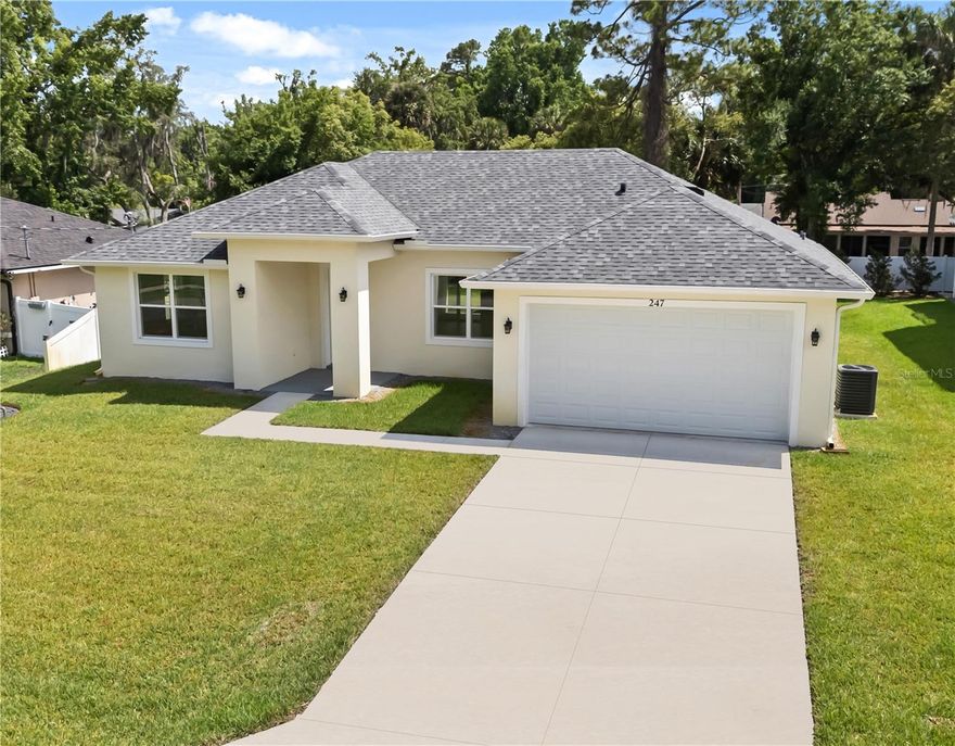 One or more photo(s) has been virtually staged. NEW CONSTRUCTION. NO HOA. LUXURY FINISHES. PRIME DEBARY LOCATION. Welcome to 247 Debary Dr., a beautifully crafted semi-custom residence situated on a spacious homesite in a peaceful, established area of DeBary — one of Central Florida’s most exciting emerging markets. With major revitalization and infrastructure projects already underway, this is the ideal moment to secure a home in a city on the rise. This remarkably spacious and meticulously designed 4-bedroom, 3-full bathroom single family home offers an airy, light-filled layout with 10-11ft.+ high ceilings, expansive living spaces, and elegant porcelain tile flooring in a soft wood-inspired finish throughout. The open-concept Great Room seamlessly blends living and dining areas, creating the perfect setting for entertaining and everyday comfort. At the heart of the home, the modern Kitchen showcases 42-inch solid wood soft-close cabinetry with crown molding, stainless steel appliances, a large 7-foot island, stunning white Carrera marble countertops and marble herringbone backsplash for timeless sophistication. The Primary Suite with tray ceiling serves as a private retreat, featuring an en-suite spa-inspired bathroom with floor-to-ceiling large format marble tile, dual vanity, walk-in shower, and oversized walk-in closet. The additional bathrooms mirror the same upscale finishes and refined style found throughout the home. Further to a dedicated laundry room with brand-new washer, dryer and utility sink, a two-car garage with long driveway for a total of 6 parking spots, bonus features include ENERGY STAR qualified windows and a whole-house WATER FILTRATION, purification, and softener system for enhanced comfort and efficiency. Step outside to a covered patio overlooking a lush generous-sized yard designed for relaxation and gatherings. Enjoy added privacy with both mature trees and Japanese Blueberry trees lining the rear of the property, and the added benefit of a well-water irrigation system complete with newly installed Rid O’ Rust system. No water or sewage bills. Ideally positioned minutes from I-4, SunRail, shopping, dining, DeBary Golf & Country Club, Central Florida Zoo & Botanical Gardens, Gateway Center for Arts, and other hotspots, this location offers both convenience and lifestyle appeal. Nature lovers will especially appreciate living within a short stroll of Gemini Springs Park, a breathtaking 210-acre destination featuring twin crystal-clear natural springs, scenic woodland trails, kayaking and canoe access to the St. John’s River, fishing pier, playground, picnic areas, dog-friendly amenities, camping, and abundant wildlife. Families will also value access to highly rated schools, including charter option and nearby Seminole County schools. Adding even greater long-term value, the highly anticipated DeBary Main Street Project will transform the area into a vibrant, walkable downtown district centered around the SunRail station, with new trail connections, community spaces, school, and other future city amenities planned as part of a major multi-modal transit-oriented development. Early buyers stand to benefit from the city’s continued expansion while preserving its desirable small-town charm. Opportunities like this are becoming harder to find in a rapidly advancing market. Seller willing to contribute toward buyer closing costs with accepted offer. Secure your place in Debary’s future! Schedule your private showing today!