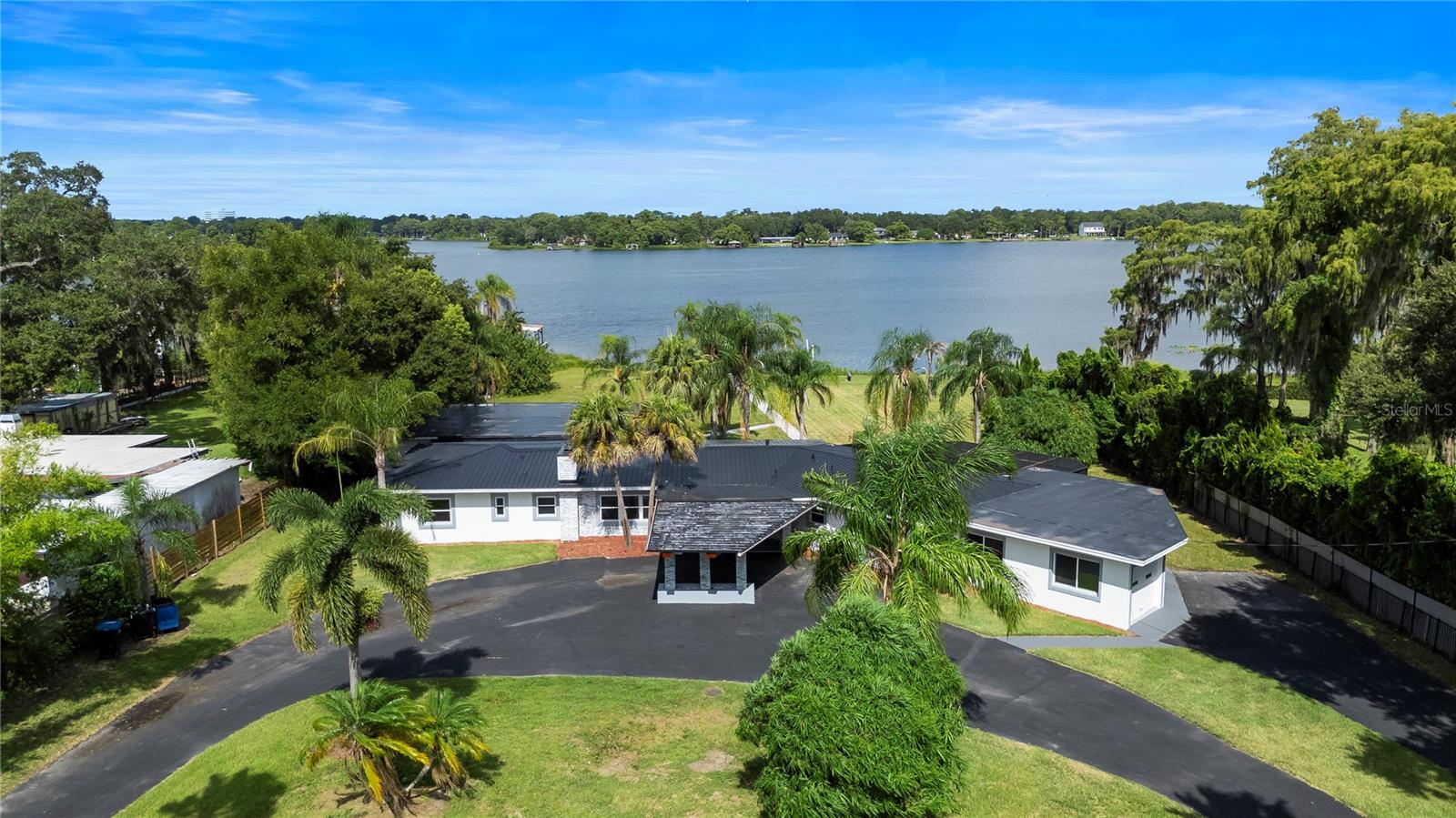 Priced below appraised value, this stunningly reimagined lakefront residence on Lake Jessamine offers an
unmatched blend of craftsmanship, comfort, and character. With over 140 feet of shimmering shoreline and
a private dock, the setting is nothing short of exceptional, offering uninterrupted sunrises and a
peaceful, natural backdrop for daily living. Step inside to a bright and fluid layout that connects the
living, dining, and kitchen spaces effortlessly. The kitchen has been outfitted with cabinetry, high-performance appliances, and tasteful stone surfaces, creating a space as functional as
it is beautiful. Every inch of the home has been revitalized with refined finishes and thoughtful
design, including elegant bathrooms with marble vanities and designer tile. A spacious flex room adds
further versatility, ready to be transformed into a media lounge, fitness studio, or creative workspace.
A durable metal roof provides long-term peace of mind, while the expansive backyard and covered lanai
invite year-round enjoyment of Florida’s inviting climate. Free from HOA restrictions, the property
offers flexibility for how you choose to live. Ideally located just minutes from sought-after schools,
major roadways, shopping, and restaurants, this home offers tranquil lakefront living without
sacrificing convenience. A recent appraisal and clean four-point inspection are available upon request
for serious buyers. Schedule your private tour today.