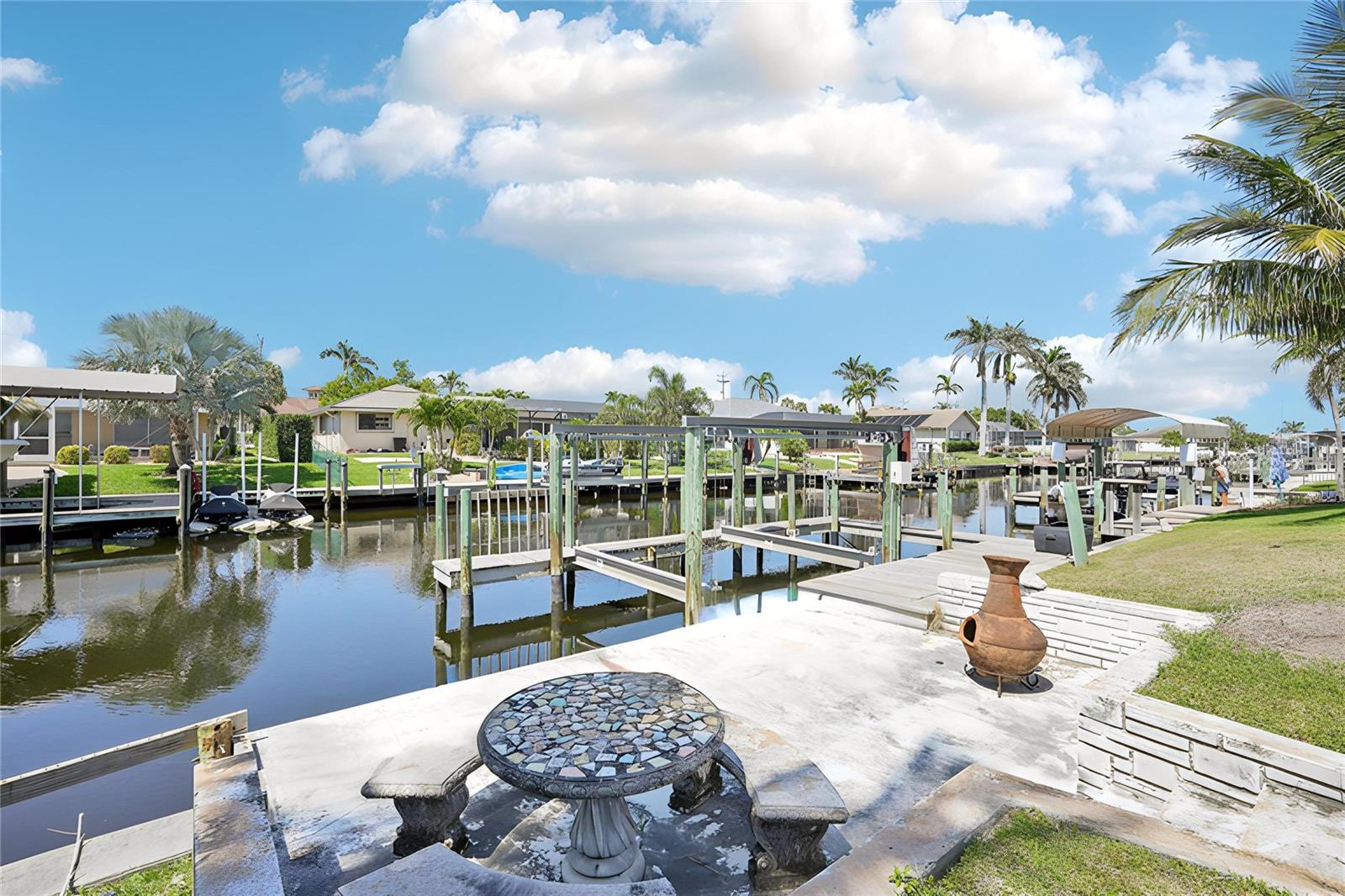 One or more photo(s) has been virtually staged. Stunning Waterfront Pool Home with Direct Gulf Access ONLY $299 A FOOT!?
SELLER WILL PROVIDE $15,000 CREDIT TOWARDS WINDOWS AND DOORS + A $1,500 CREDIT TOWARDS WASHER AND DRYER SET!
Welcome to your Florida paradise!
3 Beds - 2 Baths - 2,087 sq ft! Nestled in a highly sought-after Cape Coral boating community, this beautifully updated 3-bedroom, 2-bathroom home offers over 2,000 sq ft of inviting living space. With direct deepwater, no-bridge access to the Caloosahatchee River and Open Gulf waters, this residence is a boater’s dream.
Step inside to a bright, thoughtful split-floorplan home with a formal foyer leading to a spacious great room and dining area complete with a built-in bar for entertaining.
The upgraded kitchen features Top of the Line Stainless Frigidaire Gallery Line appliances with Real Granite Stone, and Solid Custom Wood cabinetry throughout—perfect for entertaining or daily life.
Retreat to the primary suite featuring a walk-in closet, dedicated ensuite and private lanai/pool access.
Outside, enjoy your private oasis: a large Concrete Inground Pool, Expansive sun deck, Tiki hut with brand new roof, lush tropical landscaping, private boat lift, and solid seawall with extended fishing pier—ideal for fishing, lounging, or launching your boat.
Recent Major Upgrades include a 2-year-old tile roof, up to date plumbing and electrical systems, newer pool equipment, new garage door, Waterproof Pergo flooring, and solid recently Serviced HVAC.
Everything is move-in ready—just bring your boat and soak up the Florida lifestyle.
SELLER WILL PROVIDE $15,000 CREDIT TOWARDS WINDOWS AND EXTERIOR DOORS + A $1,500 CREDIT TOWARDS WASHER AND DRYER SET!