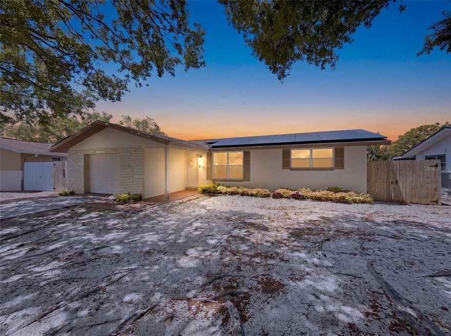 Charming waterfront opportunity in a prime Port Richey location! This well-maintained 3 bedroom, 2 bathroom home with a 1 car garage sits on a peaceful freshwater canal, offering a relaxing backdrop and added privacy - without the burden of being in a flood zone.  Step inside to find a neat and clean interior featuring stylish LVP flooring in the bedrooms and durable tile in the living spaces (NO CARPET). The kitchen is both functional and inviting, showcasing warm wood cabinetry, stainless steel appliances, and plenty of storage and prep space. Both bathrooms have been updated with beautiful stone look tile and new vanities. HVAC replaced in 2022. The layout offers comfortable living areas and nicely sized bedrooms, making it ideal for everyday living or seasonal use. Enjoy the benefits of energy efficiency with solar panels already in place - helping to significantly reduce monthly utility costs (minimal electric bill with refunds typically issued at the end of the year). The solar loan will be transferred to the new owner, providing an excellent opportunity to take advantage of long-term savings and sustainable living from day one. Whether you're looking for a primary residence, a winter retreat, or an investment property, this canal-front home offers value, comfort, and convenience all in one. Don't miss your chance to own a beautiful slice of the Florida lifestyle!