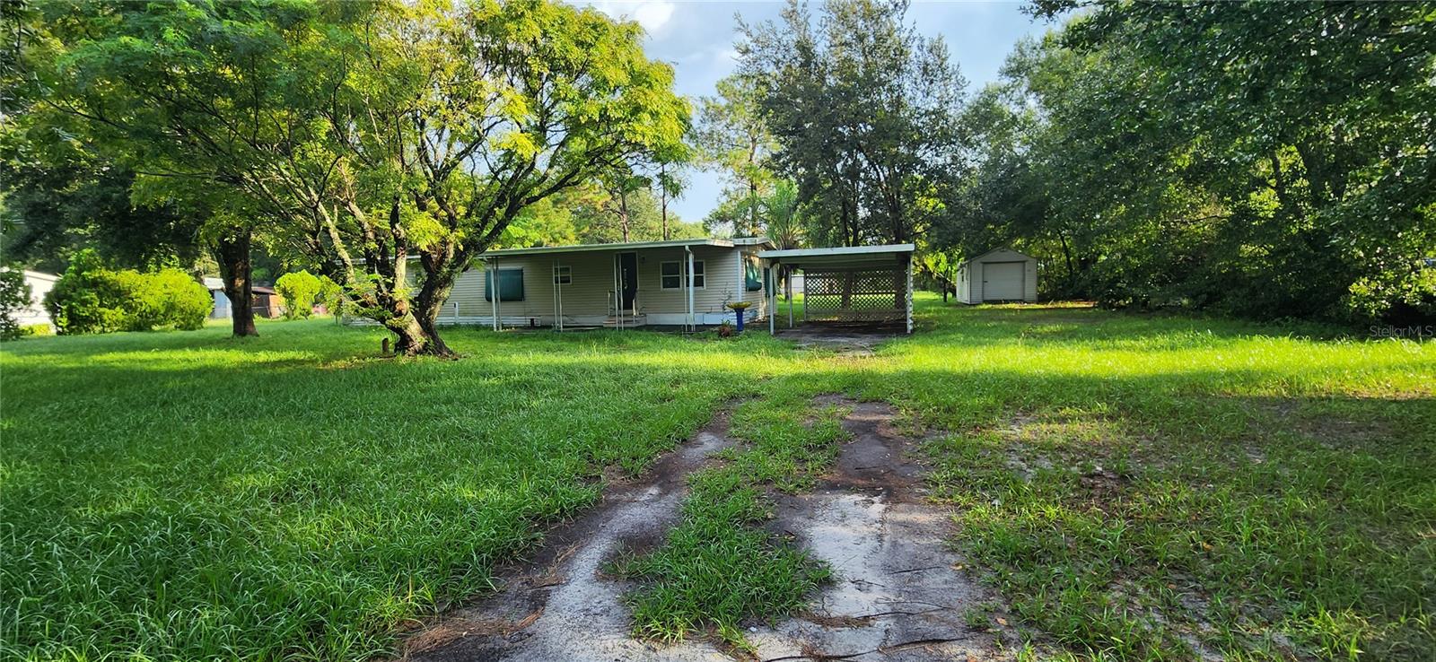 Great opportunity to own a manufactured home on over 1/2 acre lot in Wesley Chapel.