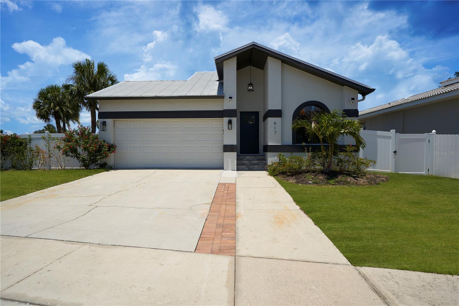 Welcome to this contemporary 3 bed, 2 bath home in Apollo Beach. The home offers a spacious living and dining area with a fireplace, vaulted ceilings, and sliding door access to the large outdoor patio. This open layout provides a comfortable and inviting space for relaxation and entertainment. The kitchen boasts solid surface quartz counters, stainless steel appliances, custom cabinetry, and a breakfast area. These modern features make cooking and meal preparation convenient and enjoyable. The primary bedroom includes an en-suite bathroom that features on-trend tile, updated dual vanity sinks, and a standing glass shower. This well-appointed space offers a private retreat within the home. The property boasts a large outdoor patio with a covered pool, providing an ideal space for hosting gatherings and enjoying the warm Florida weather. The backyard is fully fenced-in, offering privacy and security. The home also includes an attached 2-car garage, a laundry closet located in the secondary bathroom, and its proximity to Tampa Bay, just a couple of blocks away.